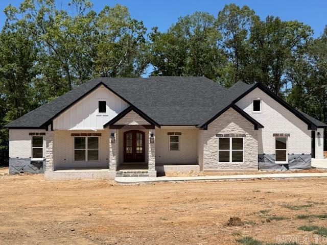 Over one acre Lakefront Lot! Enjoy the views of the lake from the big covered back porch with a vaulted tongue & groove wood ceiling. A large deck will be added for even more outdoor entertaining space. There will be room in this backyard if you wanted to add a pool later. The home is open concept with cabinets in the kitchen to the 10 ft. ceilings. The pantry is huge & will be hidden behind the cabinet doors in the kitchen cabinets. Will have a massive island with the sink in the island. The living room has a vaulted ceiling that carries out to the back porch. You will love the windows with the views of the lake. The laundry is oversized with lots of cabinets. From the laundry room you can enter the primary closet with more room than you will have clothes for. From the closet you can enter the primary bathroom. Separate tile shower & soaking tub and dual vanities. Primary bedroom is separate from the 3 guest bedrooms. Luxury vinyl flooring throughout. Lockers as you come in from the garage. The 3rd bay of the garage is extra deep (35 feet) to stow all of your lake toys and your boat. There is also room on this lot to build a shop. This subdivision is brand new. All new homes here