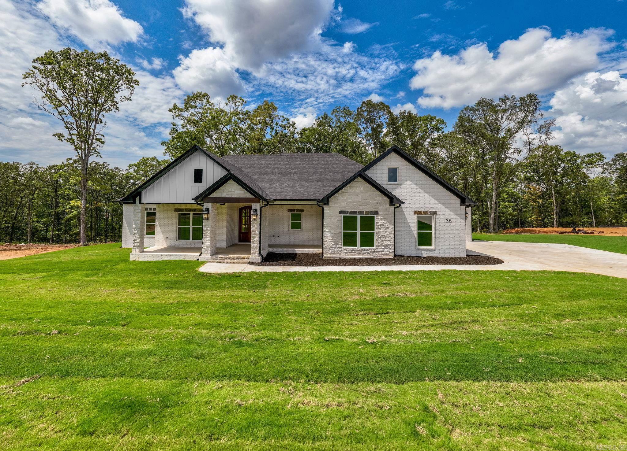 Over one acre Lakefront Lot! Enjoy the views of the lake from the big covered back porch with a vaulted tongue & groove wood ceiling. A large deck will be added for even more outdoor entertaining space. There will be room in this backyard if you wanted to add a pool later. The home is open concept with cabinets in the kitchen to the 10 ft. ceilings. The pantry is huge & will be hidden behind the cabinet doors in the kitchen cabinets. Will have a massive island with the sink in the island. The living room has a vaulted ceiling that carries out to the back porch. You will love the windows with the views of the lake. The laundry is oversized with lots of cabinets. From the laundry room you can enter the primary closet with more room than you will have clothes for. From the closet you can enter the primary bathroom. Separate tile shower & soaking tub and dual vanities. Primary bedroom is separate from the 3 guest bedrooms. Luxury vinyl flooring throughout. Lockers as you come in from the garage. The 3rd bay of the garage is extra deep (35 feet) to stow all of your lake toys and your boat. There is also room on this lot to build a shop. This subdivision is brand new. All new homes here
