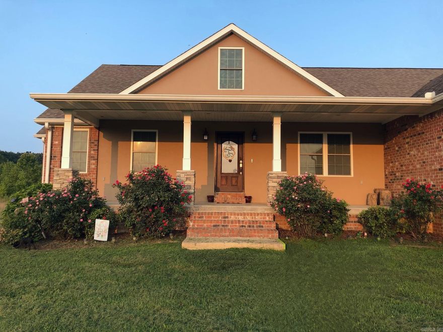 Beautiful custom-built home on 60 acres on Hwy 90 north of Rector.  56 acres m/l woods with hunting possibilities. 4 acres m/l for dwelling and storage buildings.  Five [5] bedrooms and four [4] baths and 1/2 bath. Ground floor is 2587 m/l and full finished basement at 2587 m/l.  Large primary bedroom suite on ground floor with bath with shower and tub and large walk in closet and sitting area.  Two bedrooms with shared bath on opposite end of ground floor.  Formal dining room off front entry.  Large family room with wood burning fireplace.  Large deck off back side of dwelling with stairs to lower level patio.  Kitchen has plenty of cabinets with eating bar and dinner table area.  Utility room and 1/2 bath at entrance from 2 car garage.  Lower level has bedroom, full bath, and two recreational areas.  Hunting gear room could also be an additional bedroom.  Complete concrete storm shelter/safe room.  Patio is under the top level deck.  A 20 X 30 dog pen is behind the house. Property has 2 storage buildings for boats, maintenance equipment and storage.