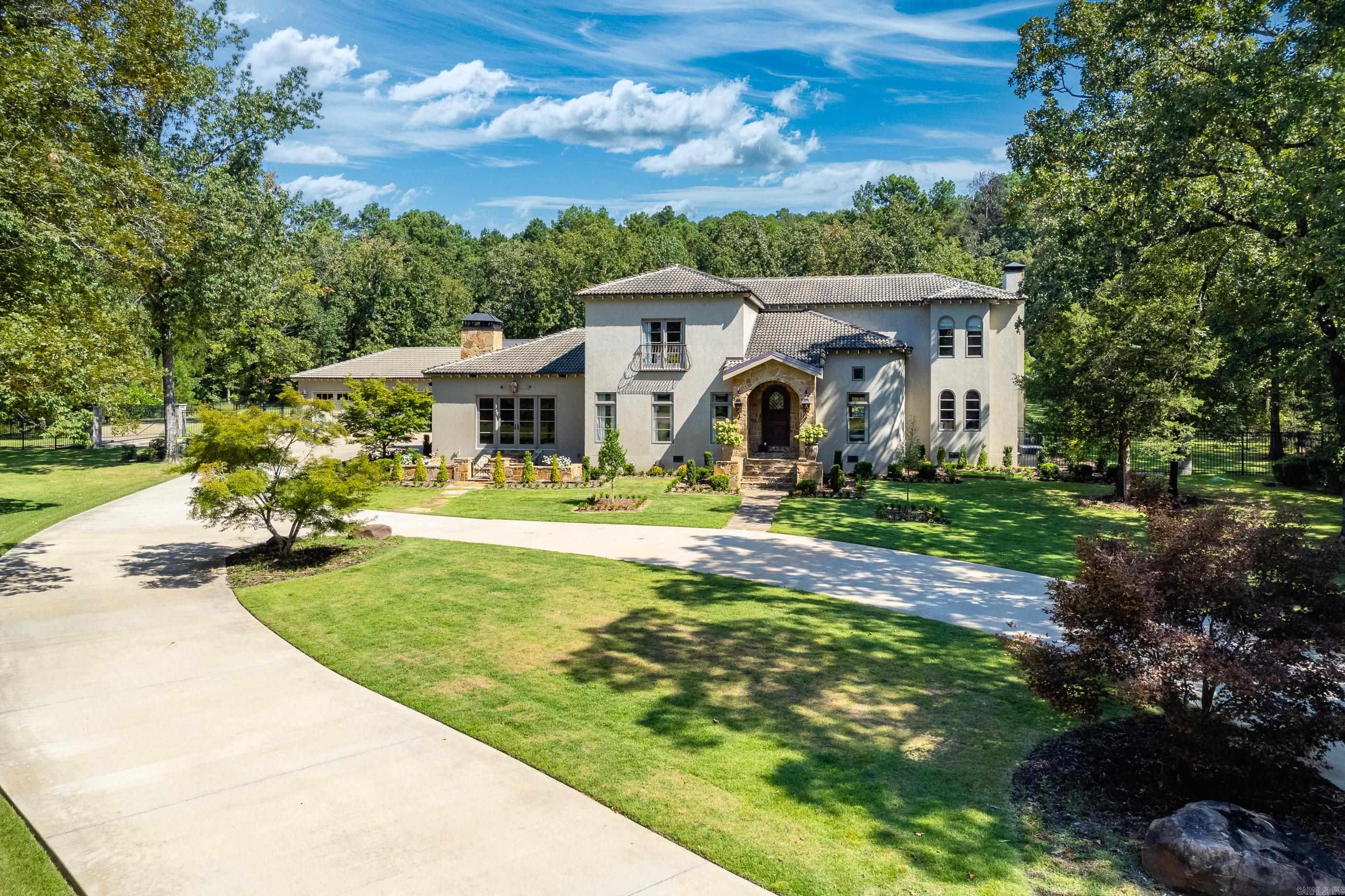 Spectacular home located on gorgeous acreage in gated neighborhood adjacent Yacht Club Marina! Exquisite design and impeccable construction. This home provides the ultimate setting for fun family living and fabulous entertaining. Handsome entry flanked by elegant formal dining and study. Gourmet kitchen open to breakfast and den with FP. Luxurious spa inspired master suite on the main level. Large family living rm w/stone FP. Upstairs: 4 br's 3 ba's. 4 car garage. Large guest house with up to an additional 4 car garage. Beautiful pool, outdoor screened porch with full kitchen, and large stone patio surrounding the pool area. Beautifully landscaped with iron fencing around the property.