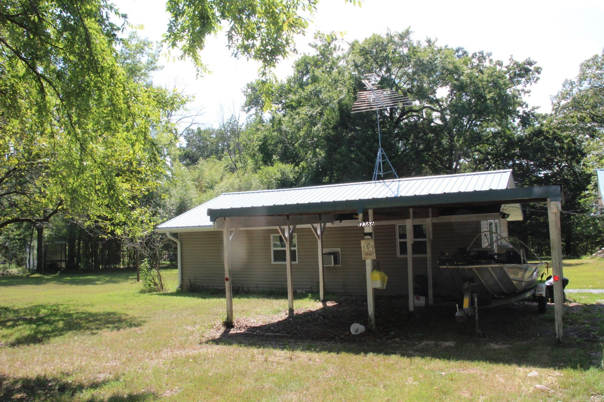 Location, location, location!! Cross the highway and you will find the entrance to the Hwy 125 campground and Marina. Enjoy the beautiful Bull Shoals Lake at your leisure. This 3-bedroom, 1 bath home offers hardwood floors, screen porch, open eat in kitchen, and a separate cabin for guests or use as a rental. The cabin includes, living room, eat in kitchen, 1 bedroom and 1 bathroom. The 1-acre lot is bordered on 2 sides by the Corp of engineers.