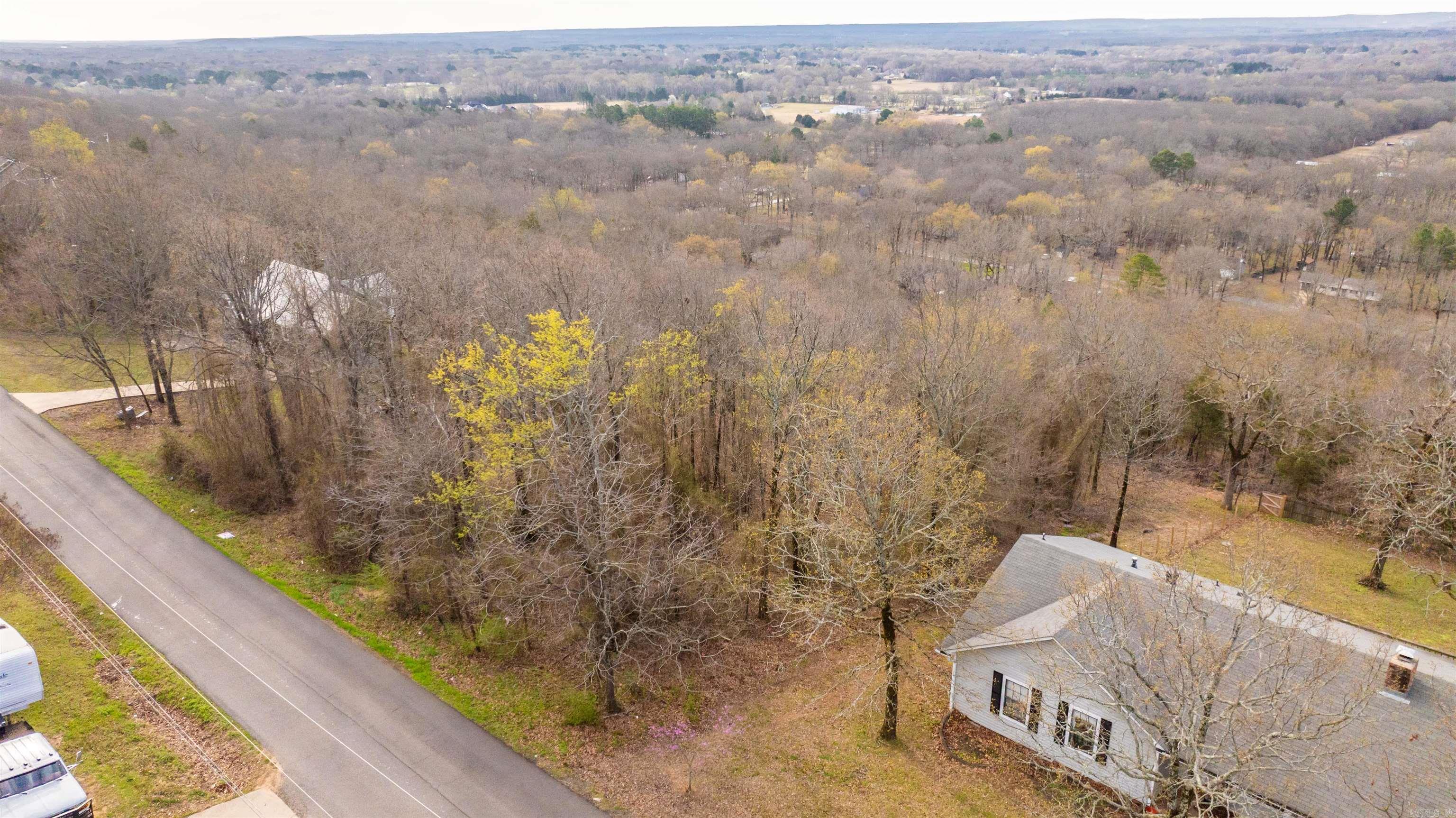 Scenic 0.7-Acre Lot in Conway. Ideal for Your Dream Home! Discover the perfect canvas for your dream home on this picturesque lot in Conway. Nestled in a serene neighborhood, this sloped terrain offers unique architectural possibilities and scenic views. With utilities readily available at the road, your building process is streamlined. Imagine waking up to tranquil surroundings while being just minutes away from local amenities. Utilities at the road. Recent perc test and survey on file. No mobiles allowed. Best value on the market!