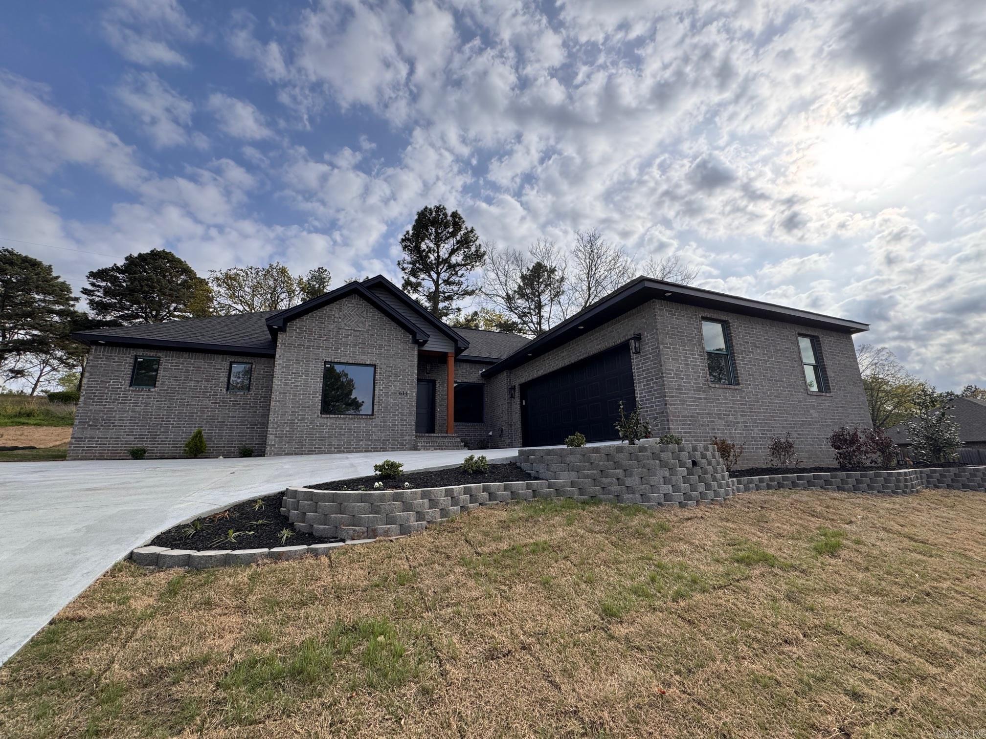 This brand new home is move-in ready! The kitchen has lots of custom cabinetry, quartz countertops, gas range, and features a large center island that is open to the living area and dining space. The dining area has a tall 10 ft ceiling, and large window overlooking the neighborhood from this hilltop lot. The owners suite is on its own side of the house and has a large bathroom with custom tile shower, freestanding tub, and double sink vanity with quartz countertops. The other two bedrooms are large and share a hall bath. Upgrades include a tankless hot water heater with instant hot water, gas heat, all LVP flooring for low maintenance. A covered back patio is private and looks onto a small backyard green space.