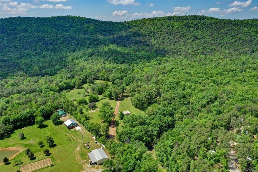 MOTIVATED SELLER ! 40 Acres of Prime Property In a Serene Setting - Perfect for Developers, Investors or a Private Retreat! Discover this Stunning 40-Acre Parcel, Ideally Located Just Minutes from Downtown Hot Springs, Cedar Glades Park and Northwood Trails with the Hot Springs City Reserve as its Picturesque Backdrop.  This Versatile Property Offers Endless Possibilities for Developers, Investors or Those Seeking A Tranquil Escape. Featuring Cleared Areas Ideal for Grazing, Farming or Development, the Land also Boast Numerous Private Trails for Hiking, Biking or ATV Adventures. A Seasonal Creek & Waterfall add Natural Beauty, while Abundant Wildlife Makes This a Hunter's Paradise. Whether you Envision a New Subdivision, A Working Farm or a Secluded Retreat, This Property Delivers Unmatched Potential. The Existing Home Offers A Foundation For Your Vision but may Require Some TLC to Shine. Note, the Access Road is a Bit Rough, But Once You Arrive, The Serene Beauty and Endless Opportunities Will Captivate You. Don't Miss Your Chance to own this Remarkable Property - SCHEDULE A VISIT TODAY!