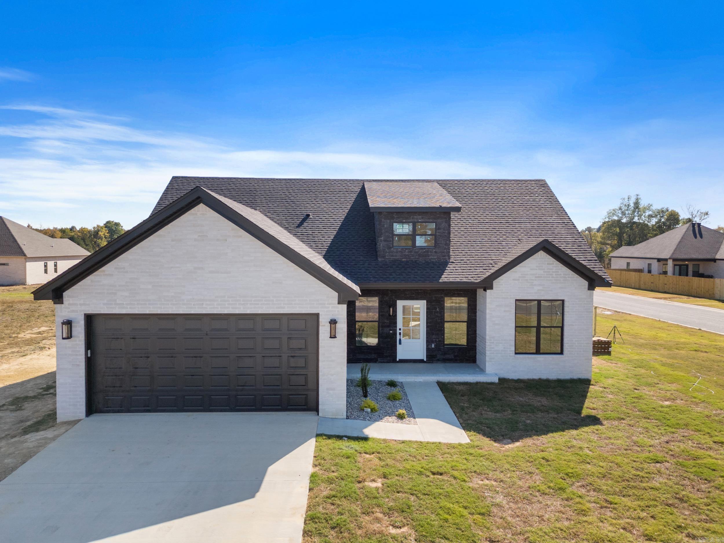 This beautiful new build by Central Arkansas Construction is situated on a corner lot and features 4 bedrooms, 2.5 bathrooms, and an array of contemporary amenities. The home showcases quartz countertops, stainless steel appliances (REFRIGERATOR STAYS), custom cabinetry, and a spacious walk-in pantry, ideal for those who love to cook. A functional laundry room adds convenience. The open living space, with LVP flooring, extends effortlessly to a covered patio and FENCED BACKYARD, creating an ideal setting for outdoor gatherings. The primary and guest bathrooms are stylishly tiled, offering a tranquil retreat. Don’t miss out on the opportunity to make this stunning property yours! Agents, please see agent remarks.