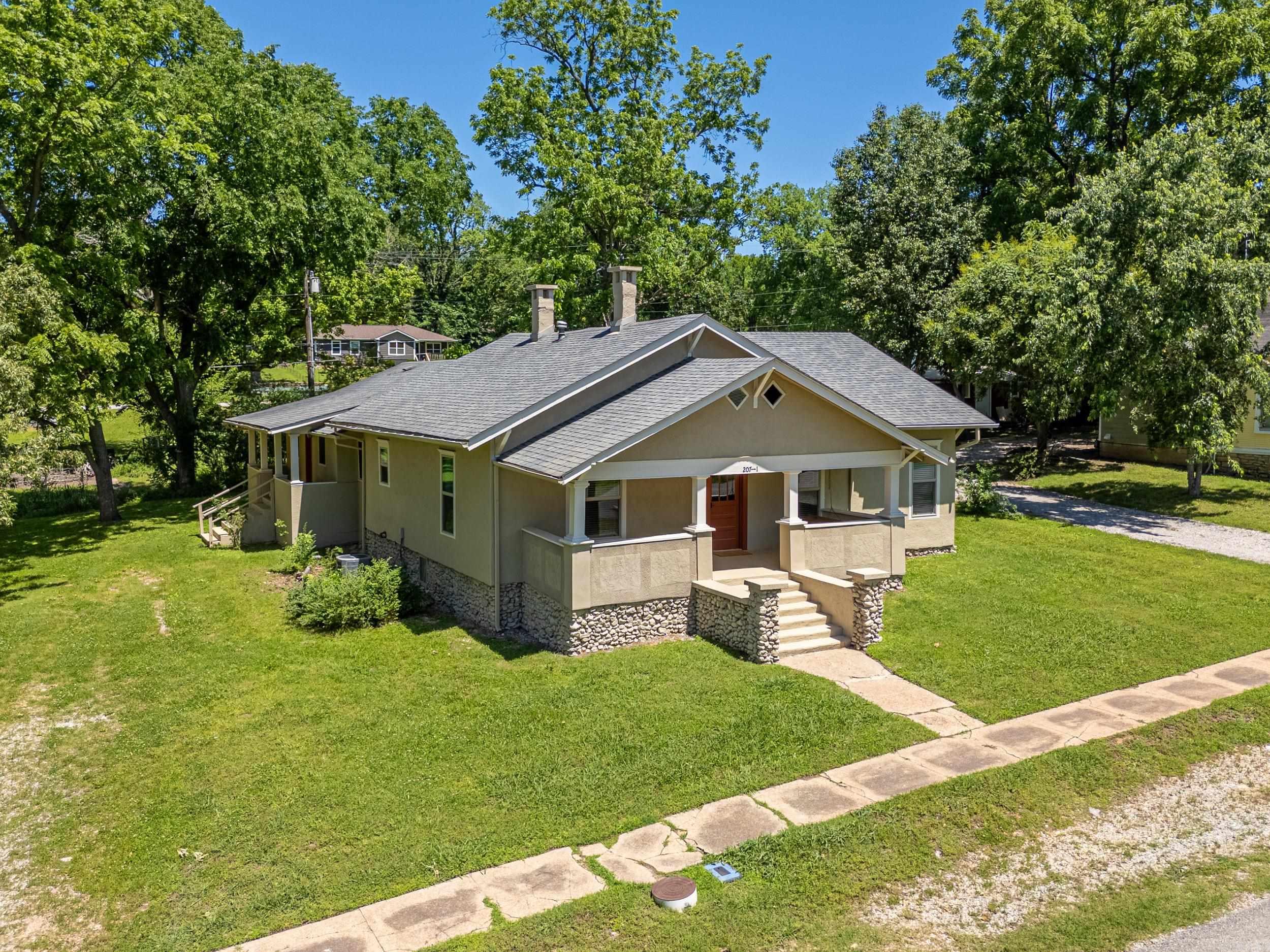Discover a unique investment opportunity in Cotter, Arkansas. This versatile duplex, built in 1940, offers a total of 5 bedrooms and 2 bathrooms across 2,202 square feet, thoughtfully divided into two distinct units. Unit 1: Spanning 1,178 sq. ft., this unit features 2 bedrooms and 1 bathroom. Enjoy stylish wood flooring, a well-equipped kitchen with a wall oven, gas cooktop, and refrigerator, plus washer/dryer hookups for added convenience. Unit 2: Covering 1,024 sq. ft., this unit boasts 3 bedrooms and 1 bathroom, along with an additional room perfect for a sitting area or home office. The living spaces are adorned with laminate flooring, while the bedrooms offer cozy carpeting. The kitchen includes a gas stove/oven and refrigerator, and the unit comes with a washer and dryer already installed. Situated on a 0.3-acre m/l lot, this property is ideal for investors seeking rental income or homeowners desiring a multi-generational living arrangement. Its prime location in Cotter provides easy access to local amenities, world class trout fishing and Cotter Public Schools.