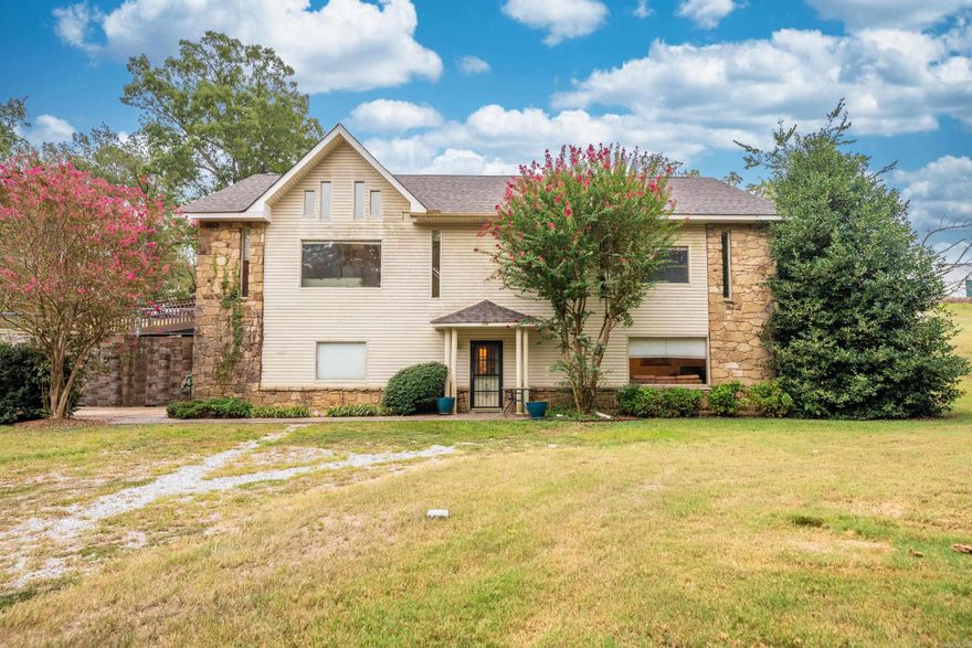 Discover the ultimate in flexible living with this well-maintained home or duplex featuring a 2-bed, 2-full bath main living area boasting vaulted ceilings, a cozy fireplace, a fenced-in yard, and a garage upstairs, while the downstairs offers a 1-bed, 1-bath in-law suite complete with an office, full kitchen, laundry room, a separate entrance, and a garage. Recent updates include a new roof and gutters. Plus, an extra lot provides potential for future expansion. Ideally located near shopping, hospitals, Oaklawn Race Track, and a variety of restaurants, this property offers a unique blend of comfort and convenience. Siding is in the process of being repaired. Call today to schedule a showing and seize this versatile opportunity!