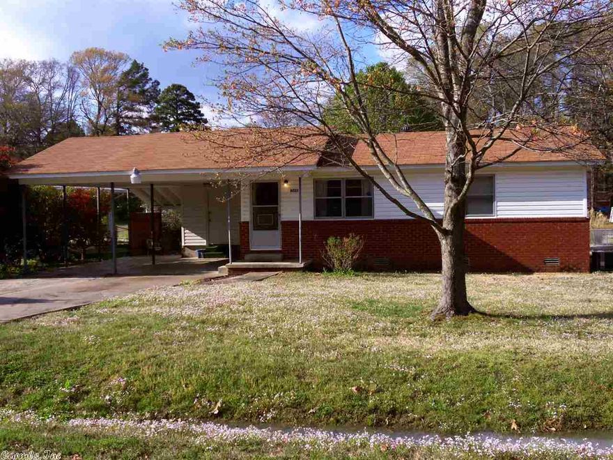 Attractive brick/vinyl home on over 1/2 acre lot.  Living room with big picture window and built-ins.  Cozy kitchen with gas range.  Updated bath.  Fresh interior paint.  Third BR or extra den/office/utility room.  Big 2 car carport with outside storage, plus approx 10x16 Morgan building/ shop with electricity & additional covered 10x16 extra covered storage. 11x22 covered patio.  Drive thru access to back field.