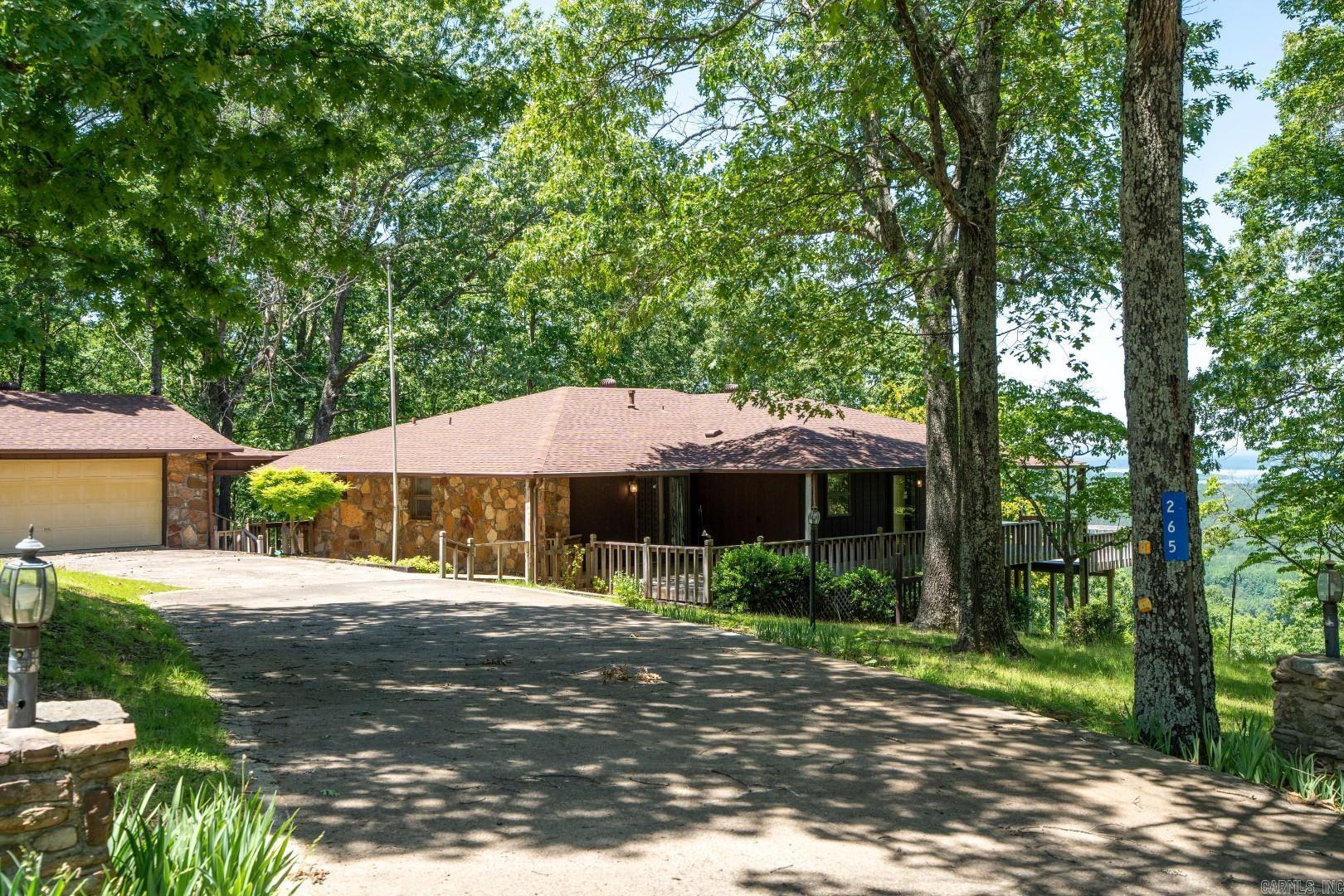 Lovely home on 15 acres with fantastic view of Greers Ferry Lake! Located just 10 minutes from downtown Heber Springs, this extremely well-care-for home includes 3 bedroom, 3 full baths, 2 livings areas, downstairs kitchenette, lots of storage, large living area with walls of glass (Andersen windows) overlooking Heber Springs and Greers Ferry Lake, wrap around deck, a 2-car garage and a 1-car garage and immense privacy! The home sits on 3 large lots (totalling about 5 acres) and also includes an additional 10 acres below (down the hill from) the house that helps protect the views!