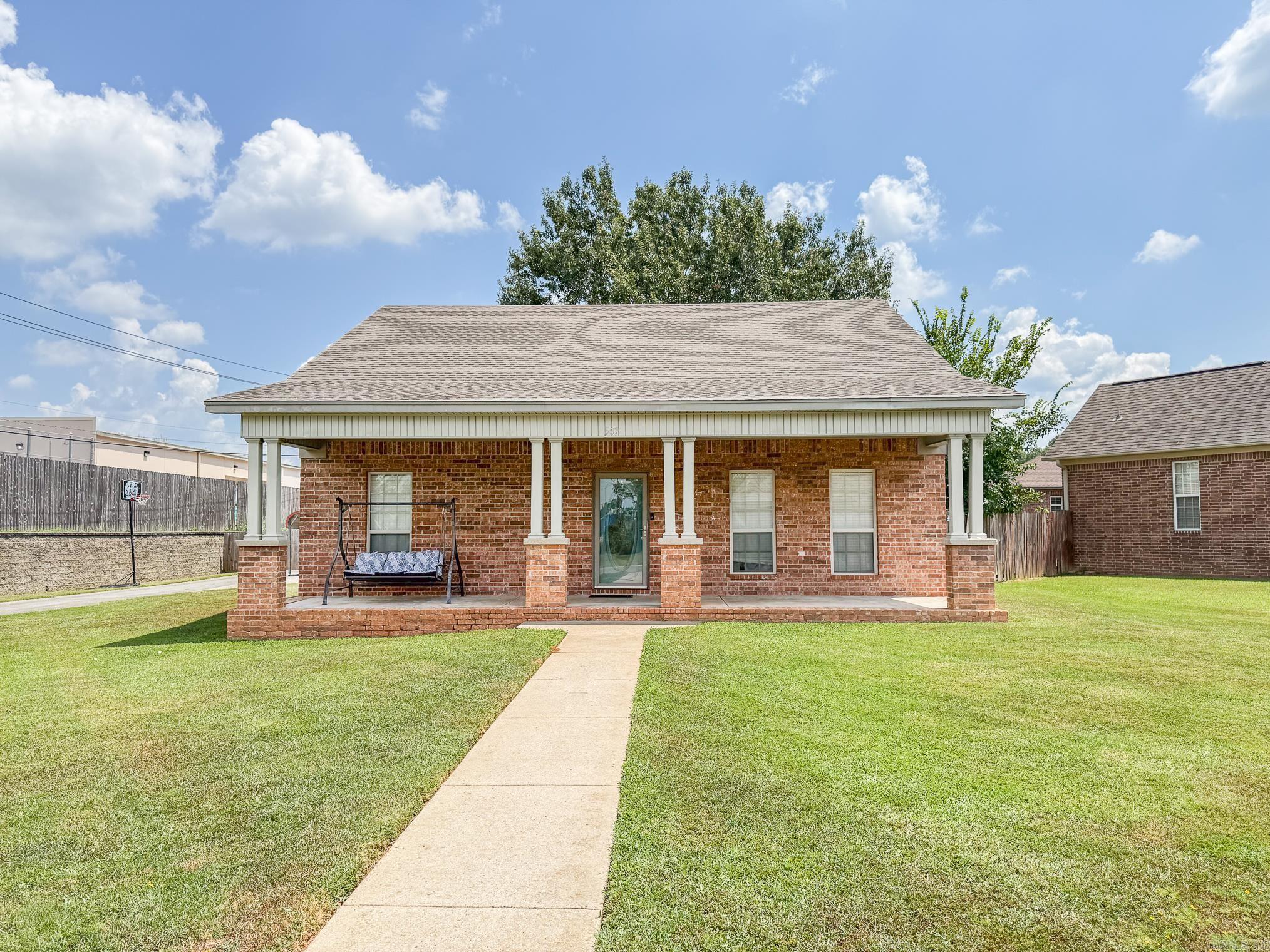 Beautifully updated home in a great location! With 3 bedrooms, 2 baths, approx 1407 sq ft with fenced in back yard.....this one is move in ready. The inviting front porch is large enough for all of your holiday decorations. The living room has pretty rock fireplace and wood laminate flooring. The kitchen has plenty of cabinets, quartz countertops, pretty backsplash and breakfast bar. Spacious master bedroom is separate from the others. No carpet in the house. Laundry room with folding table. Large backyard, side load garage, extra parking pads. Roof 2022.