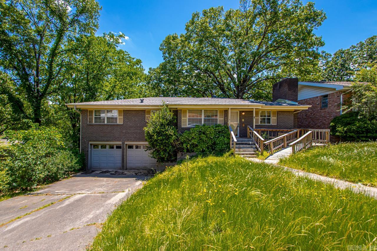 This split-level home in the established Crosswinds subdivision offers a fantastic opportunity for investors or owner-occupants ready to add value and make it their own. With three bedrooms on the main level, a flexible layout featuring both a great room and a family room, and a functional eat-in kitchen with a breakfast bar, there's plenty of space to work with. The home includes a two-car garage, central heat and air, and bonus features like a wood-burning fireplace, laundry area, and a mix of laminate, vinyl, and luxury vinyl flooring. Outside, you'll find a sloped lot with extra landscaping, a deck, patio, and front porch—perfect for future outdoor updates. Whether you're looking for a solid rental, a renovation project, or a home to customize and live in, this North Little Rock property is worth a look. NEW ROOF MARCH 2025!