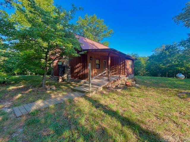 This could be the property you are looking for! Escape to this beautiful Custom built cabin sitting on 10.30 acres m/l & no restrictions. With two bedrooms and 1 and 1/2 bathrooms,this home blends rustic charm with modern comfort. The custom rock fireplace in the living room creates a cozy gathering spot, while the unique rock shower adds a touch luxury to the bathroom.This property has a beautiful wet weather creek that flows most of the year,with beautiful rock formations and cascading water creating a great atmosphere There is a 16x24 carport,a 16x12 outbuilding and there is also a deck off the back of the house that leads to a 24x16 building that could easily be turned into a guest room or apartment.It could be whatever you want to make it. it has power and a heat and air wall unit.Deer and turkey roam the property, making it a nature lover's paradise. Whether you are soaking up the sounds of the creek or enjoying the wildlife or working in the garden,this property has it all. Located only 20 minutes from Mountain View Arkansas, the Folk Music Capital of the World. The White and Red River are also nearby for all your fishing, hiking and floating. Get your showing booked today.