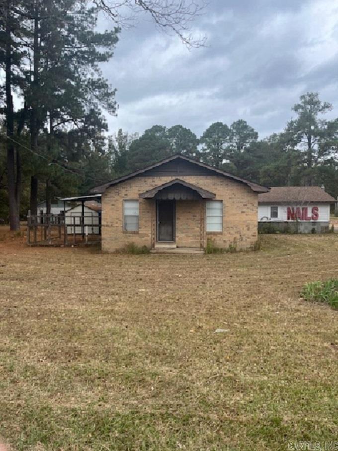 This older home was updated in 2018. Granite counters, new cabinets in remodeled family room, bathroom remodeled and part of this house can be used as nail or hair salon. Two rooms are set up as storage rooms with built in shelves. Storage building off of patio area. This is the perfect house for you to have your own business in your home. In the backyard is a 2,400 sq. ft. warehouse building just waiting to be made into something you want. Great location right off of California Ave./US Highway 79. All on over 1 1/2 acres. **Water Heater 2021, CH/A 2008, New cabinets, stove, countertops, flooring all 2018. **Commercial Building behind house that conveys with property is 2,400 sq. ft. built in 1994. This property contains two parcels. With both it is commercial & residential.