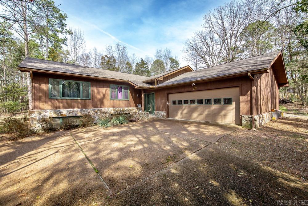 Welcome to your dream home on the picturesque Mountain Ranch Golf Course. This home is on a large lot (3 lots replatted into one) ensuring privacy. As you enter the home, you'll be immediately captivated by the heated & cooled sunroom, overlooking the scenic Fairway 2. Imagine enjoying your morning coffee or hosting gatherings in this tranquil space while taking in the panoramic views. The wall of windows & vaulted ceiling in the main living area create a bright & airy atmosphere. The upgraded granite countertops, newer appliances, & large walk-in pantry make the kitchen a chef's paradise. The beautiful stone fireplace, provides warmth & coziness during the colder months. The main level comprises 2 spacious bedrooms & 2 bathrooms, while the lower level features two bedrooms & 1 bathroom, & a den. The property also boasts a lovely patio area in the back, perfect for outdoor relaxation, barbecues, & enjoying the gorgeous views of the golf course. Greers Ferry Lake is just 10 minutes away. Other amenities include 3 swimming pools, hiking/biking trails, atv/utv, tennis courts, pickle ball, bowling alley, putt putt golf & other activities which make this a great place to live.