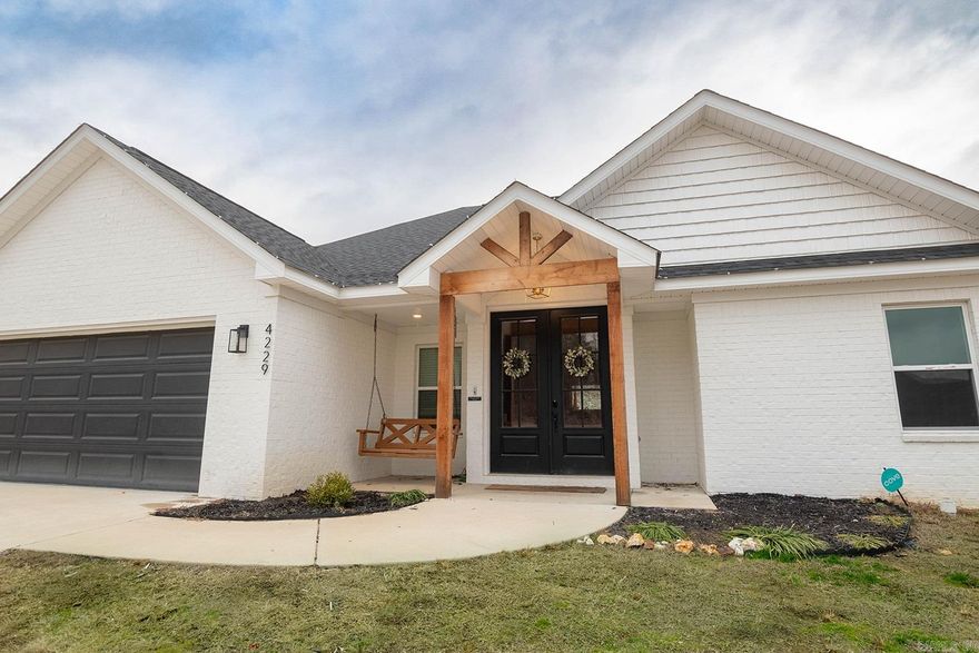 Welcome to 4229 Hampton Dr in Crossroads Village—a stunning custom-built home by Mark Investments awaits you! This 4-bedroom, 2.5-bathroom residence spans 1980 sq ft and is situated on a generous 1/2 acre lot, providing ample space and privacy. Step inside and discover the open-concept living room that features a brick gas fireplace with floating shelves. The kitchen boasts with quartz countertops, stainless steel appliances, & a hidden walk-in pantry, offering not only functionality but an abundance of storage space for your culinary delights.  The split floor plan ensures a perfect balance of privacy and togetherness for you and your loved ones. Practicality meets style with a designated mud area & 1/2 bath when you walk in through the garage. The kids' rock wall adds a touch of adventure and playfulness, creating a unique and enjoyable environment for the younger members of the family. As you explore the outdoor space, you'll find delightful features that elevate your living experience. Unwind in the hot tub, providing the perfect retreat for relaxation after a long day. For those who love to entertain, the gas hookup for the grill makes hosting gatherings a breeze.