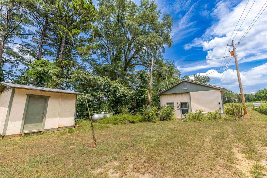 Looking for a peaceful getaway or the perfect fishing spot? This enhanced mobile home on two lots sits right on the lake and makes a great retreat, weekend hangout, or full-time escape.  About 800 feet from Upper and Lower Jack's Landing, your fishing opportunities couldn't be more convenient!  Inside, it’s comfy and inviting with a nice step-down den that’s perfect for kicking back after a day on the water. The space has been fixed up for easy living, but still keeps that relaxed, camp-style vibe.  Matching outbuilding conveys.  Outside, you’ve got lake views, room to spread out, and direct access to fishing, boating, or just enjoying the quiet. Whether you’re into early morning coffee on the porch or casting a line at sunset, this place has you covered.  Furnishings are negotiable!