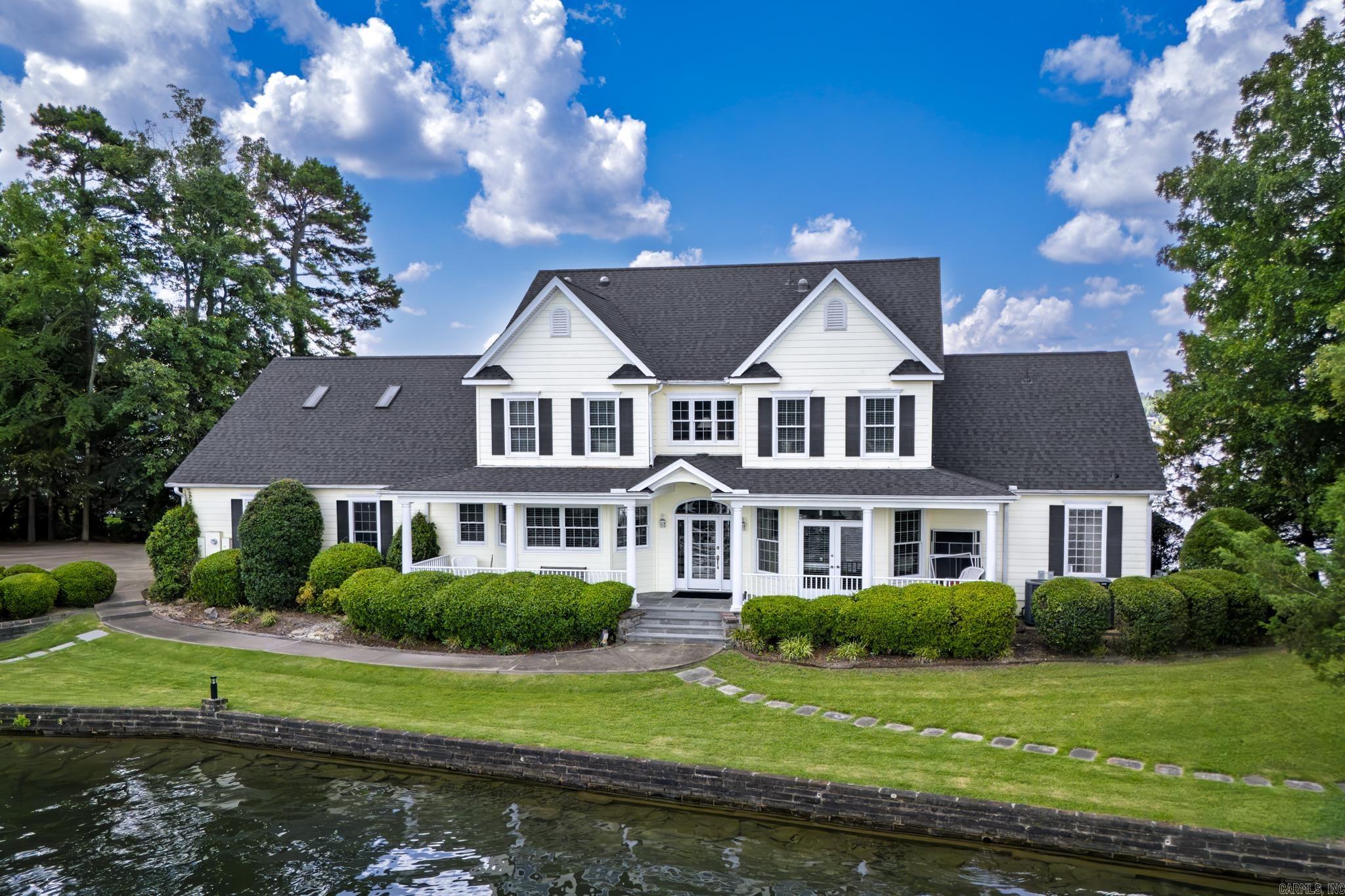 If you dream of owning a lake home on your own private peninsula, you need to see this home! It has 500 feet of shoreline on almost an acre of land on Lake Balboa, the largest lake in Hot Springs Village. Spectacular lake views from all sides of the home. It has a covered boat dock with a lift. The kitchen offers lots of cabinet space and an island with refrigerated drawers. Master bedroom is on main level of this 2 story home. New roof 2025. Water heater 2021(instant hot water!) Hot Springs Village has a one-time buy-in fee of $2,000 paid at closing.