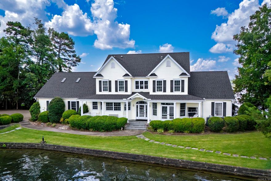 If you dream of owning a lake home on your own private peninsula, you need to see this home! It has 500 feet of shoreline on almost an acre of land on Lake Balboa, the largest lake in Hot Springs Village. Spectacular lake views from all sides of the home. It has a covered boat dock with a lift. The kitchen offers lots of cabinet space and an island with refrigerated drawers. Master bedroom is on main level of this 2 story home. New roof 2025. Water heater 2021(instant hot water!)  Hot Springs Village has a one-time buy-in fee of $2,000 paid at closing.