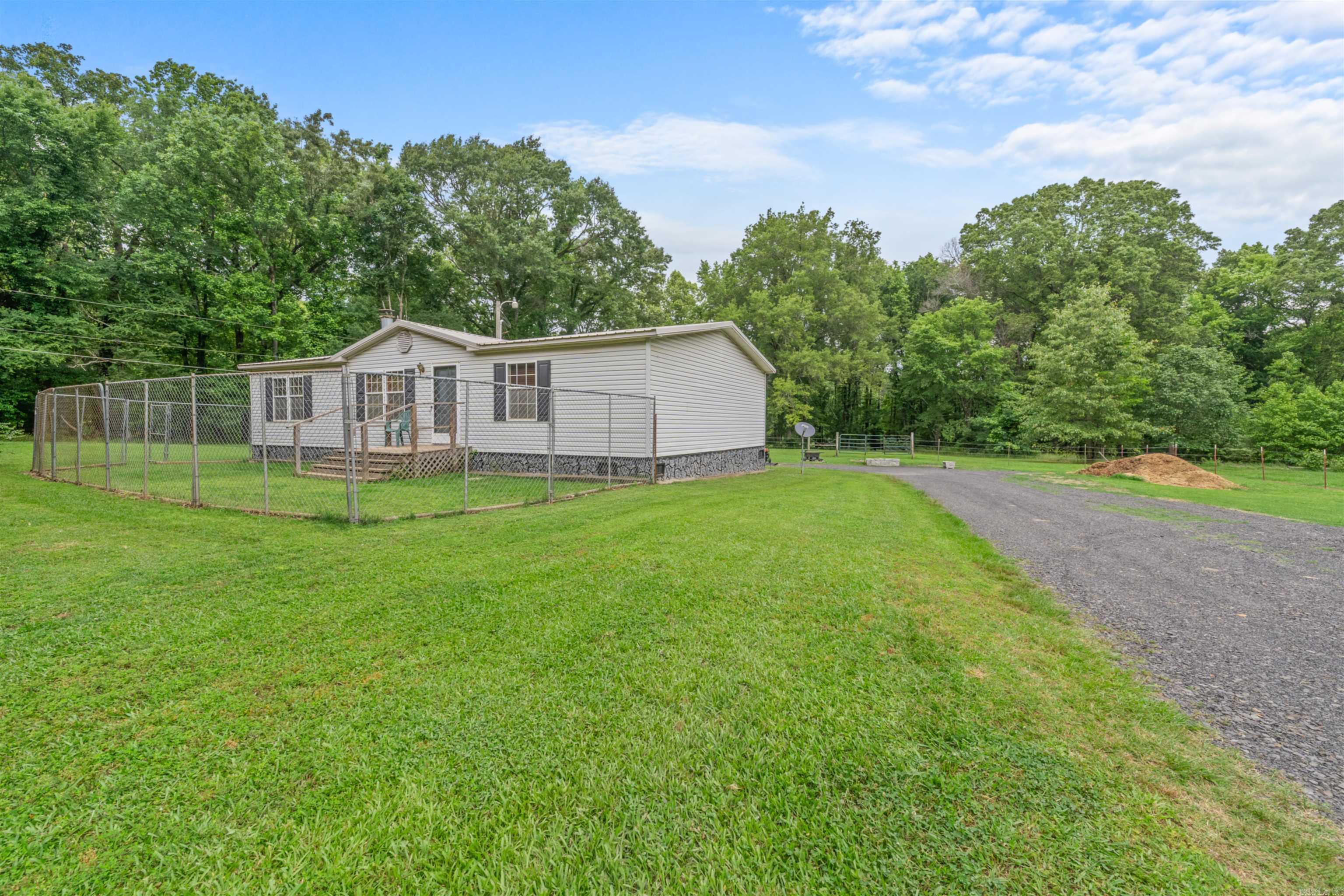 HORSE LOVERS DREAM! Well maintained, one owner 3br/2bath on permanent foundation with nice covered carport/patio area, nestled on 6.5 acres. Property features and impressive 80x100 covered metal riding arena with additional stall space along one the side.-- perfect for training year round. Also includes another small barn & horse walker. Home features Newly remodeled primary bathroom with a modern walk in shower. Walk in Closets. PLUS Storm Shelter. Grand Prairie Water / First Electric Set up for young trainer, HOBBY FARM, or any able to enjoy the Large covered area. #startyourmovetoday