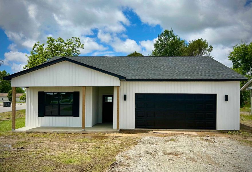 Welcome to your dream home! This stunning 3-bedroom, 2-bathroom residence boasts 1560 sq ft of living space with modern finishes throughout. The kitchen features elegant granite countertops, custom cabinets, and a farmhouse sink, complemented by a stylish backsplash. Cozy up to an electric fireplace in the living room. This home also includes luxury vinyl plank flooring, 9-foot ceilings, all-electric appliances, and a convenient mudroom.   Relax in the spacious master bedroom with a large closet. Enjoy the luxury of a custom tile shower and a freestanding tub in the bathroom.     Located on a desirable corner lot, you'll be within walking distance of Stewart Park, the city pool, baseball fields, and future pickleball courts. Don't miss the opportunity to own this beautiful home!  The listing agent, Jonathan Quesada, with United Country Scenic Rivers Realty is a licensed Real Estate Professional and has a financial interest in the property being offered for sale.