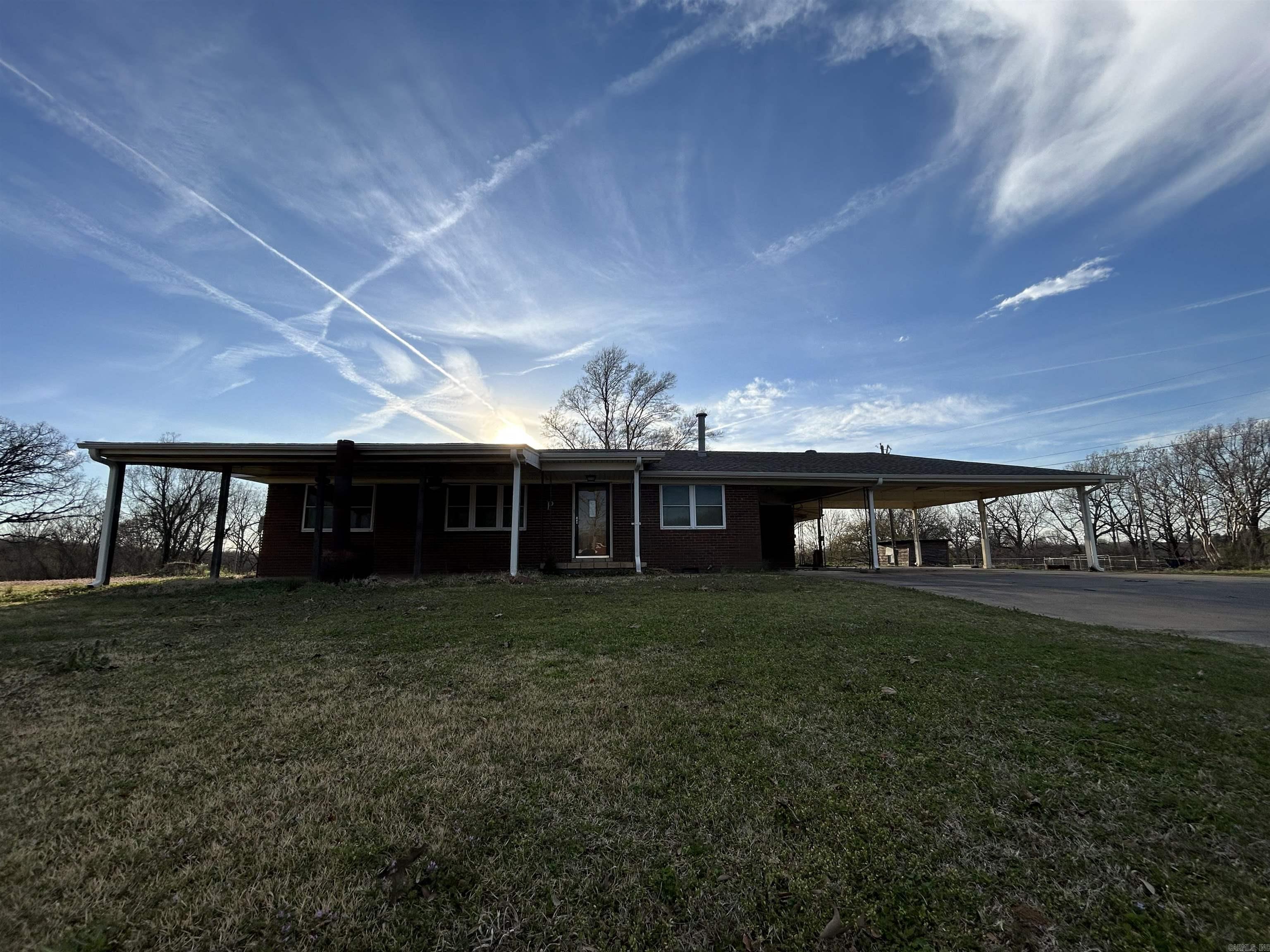 Lots of outdoor living space with a large front porch, spacious carport (large enough for 3 vehicles) and two storage sheds.
