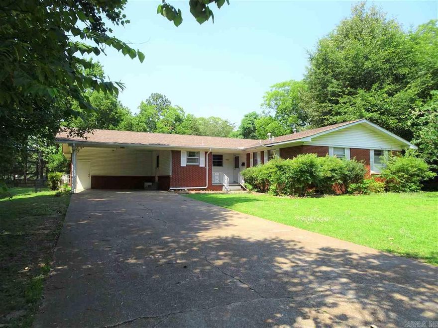 TWO houses in one! This 3BR 2BA home also has an attached apartment. The main home has 2 living areas, large bedrooms and a great covered patio area that also connects to the apartment. You can close off the apartment and have outside access only or leave open for a walk-thru. The apartment has, bed space, living space, full kitchen and full bath. The yard is over 1/2 acre with outside storage. There is also under carport storage. This home has recently had new paint, bathroom updates, new flooring, old carpet removed to expose beautiful original hardwoods, some new fans, fixtures and more. There is currently a tenant with a lease through JULY. SEE showing remarks.