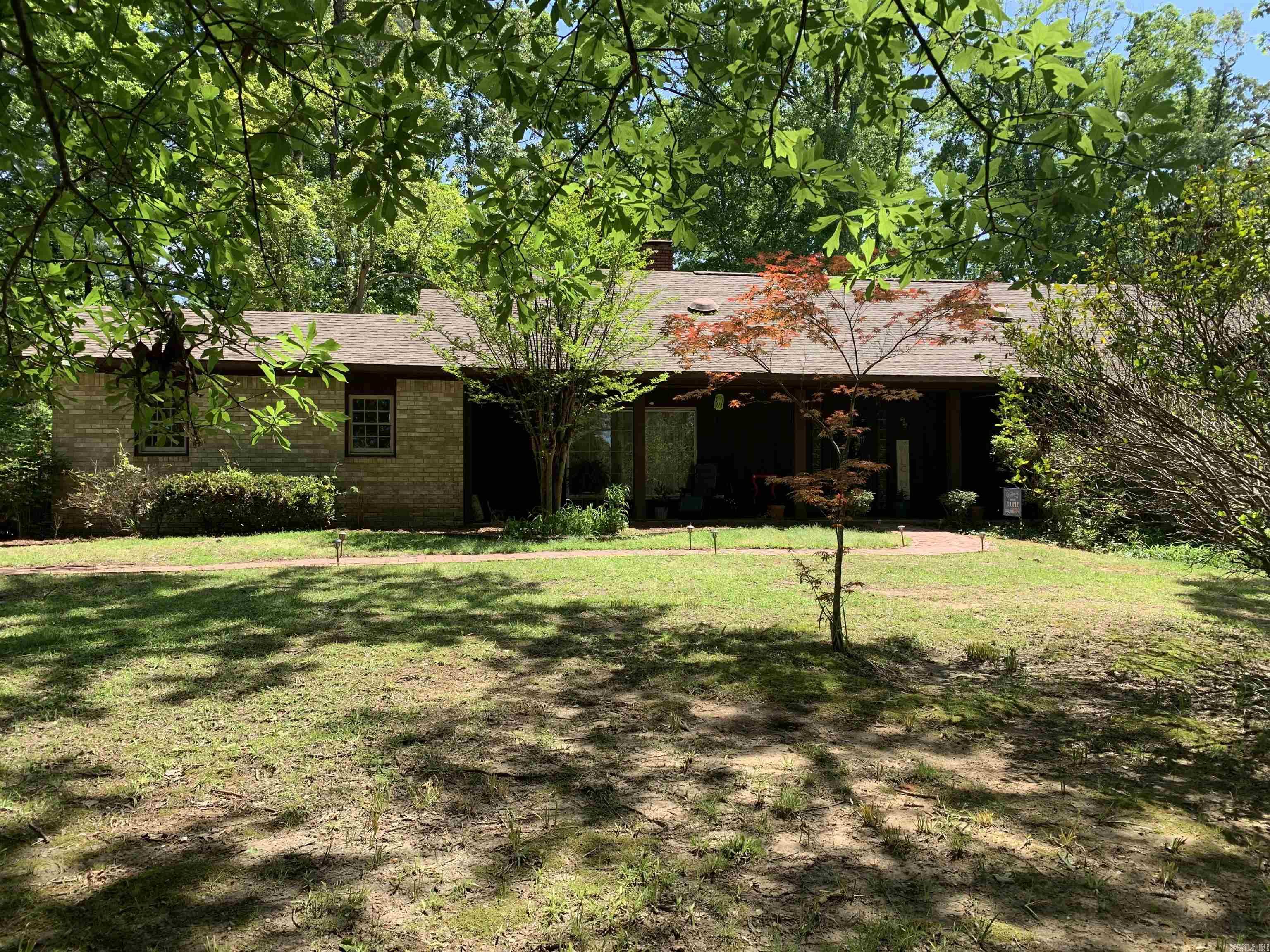 Start calling this rare & charming property home today! You will fall in love with the country feel of 7 private acres while still having city amenities. Wood floors welcome you into the foyer, large living room with stone fireplace and built-in bookcases. The kitchen has a picture window over kitchen sink to take in the scenery, center island with storage, wall oven, cooktop, microwave, & refrigerator. Open kitchen and family room keep everyone connected and the adjoining dining room has so much charm with the cathedral ceiling and 2 walls of windows overlooking the natural wooded landscape. Split floor plan with 2 bedrooms downstairs and 2 bedrooms upstairs. Downstairs primary bedroom offers fireplace and access to deck. The landscape is a horticulture's dream and boast beautiful iris's, azaleas, dogwoods, red maple trees and has a 12' x 20' storage building with a separate breaker box and wall heater. Upstairs has attic access that is floored for extra storage Downstairs has fresh paint through most rooms. *Curtains are negotiable