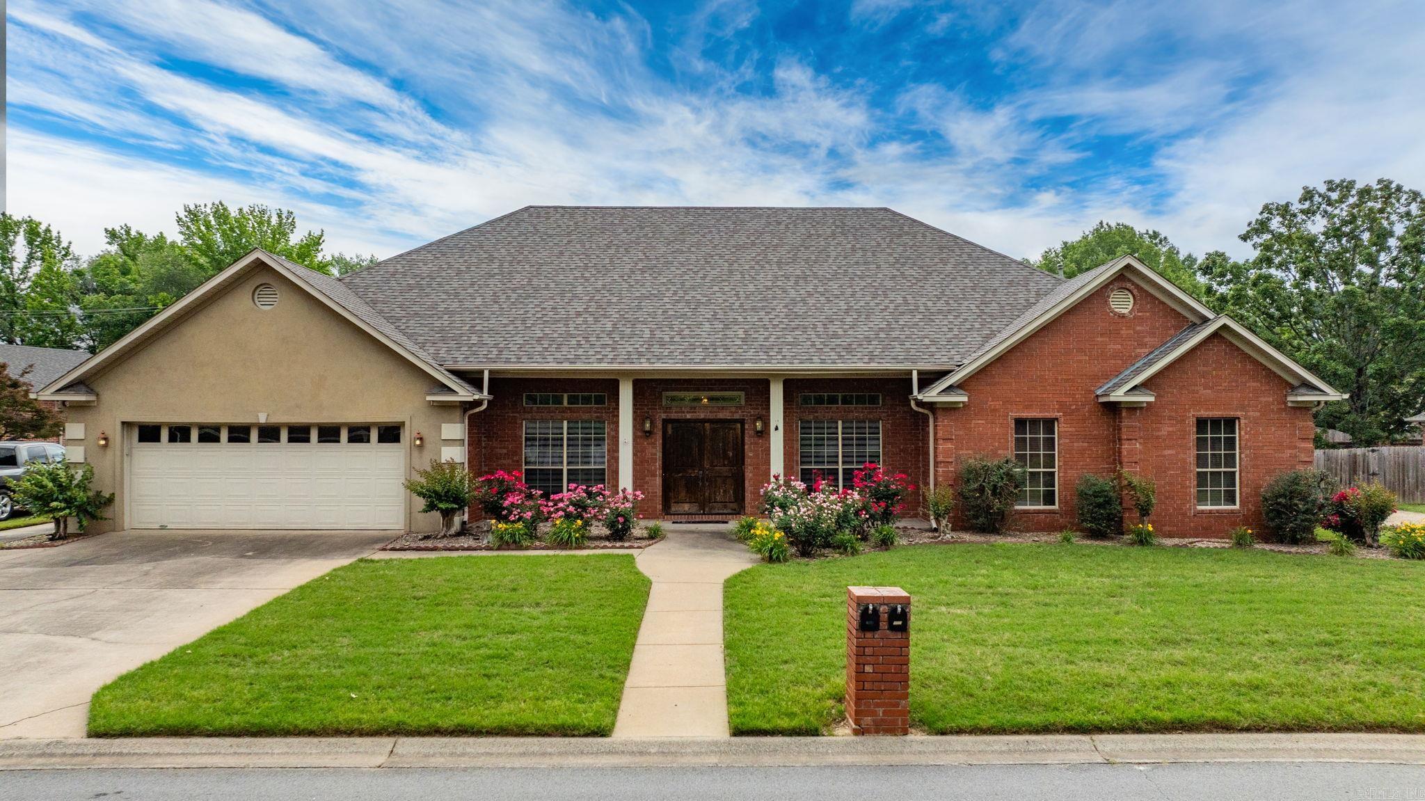 This home has space for everyone. Office space and formal dining room opposite each other as you enter through the double front doors. The living room is large with a vaulted ceiling and a woodburning fireplace. The kitchen is roomy with plenty of workspace. Pantry located in the nearby hallway. The laundry room is huge with space for both a full size freezer and second refrigerator. The 4th bedroom is off the kitchen and would make a great mother in law space. It has a full ensuite, walk in closet and access to the backyard. Two guest bedrooms and the primary bedroom are at the opposite end of the home from the 4th bedroom. The primary bedroom is oversized with a door to the backyard. The closets are both walk in. Nice ceiling with extra height in the primary bedroom. The primary bathroom has a separate shower and tub. The shop is 20X20 with a concrete driveway. Roof is only 2 years old. Fence on the south side of the yard is new. Extra insulation added in attic and tint on the windows on sun facing sides for extra energy efficiency. Central Vacuum. Variable speed zoned HVAC unit. Enjoy the convenience to I40 and all of Conway in this central location.