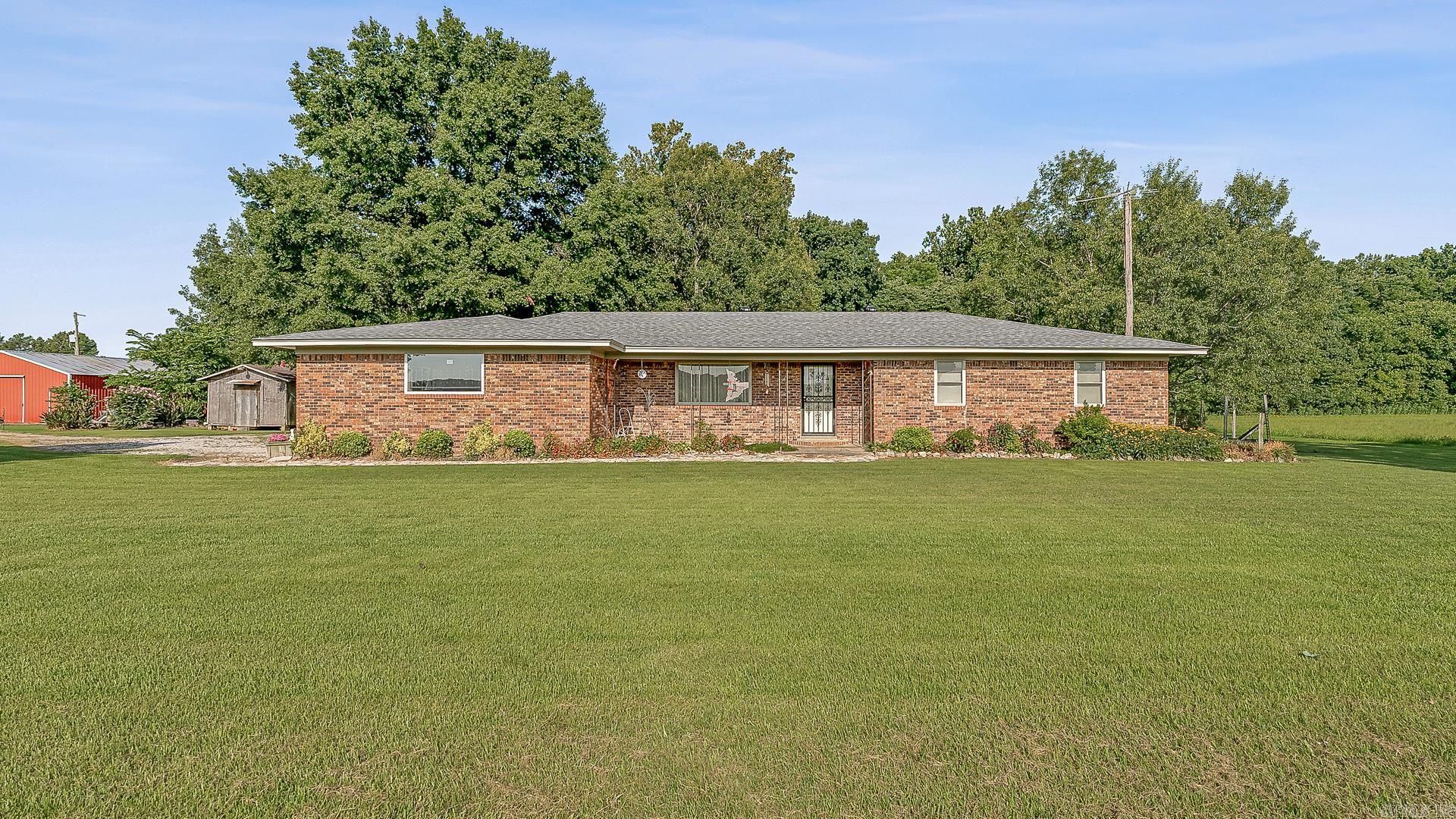Escape to the tranquility of country living with this exceptional property! 5645 Hwy 1 offers approximately 40 acres of land just outside Harrisburg, AR, and boasts a brand-new roof giving you peace of mind and a move-in-ready experience.