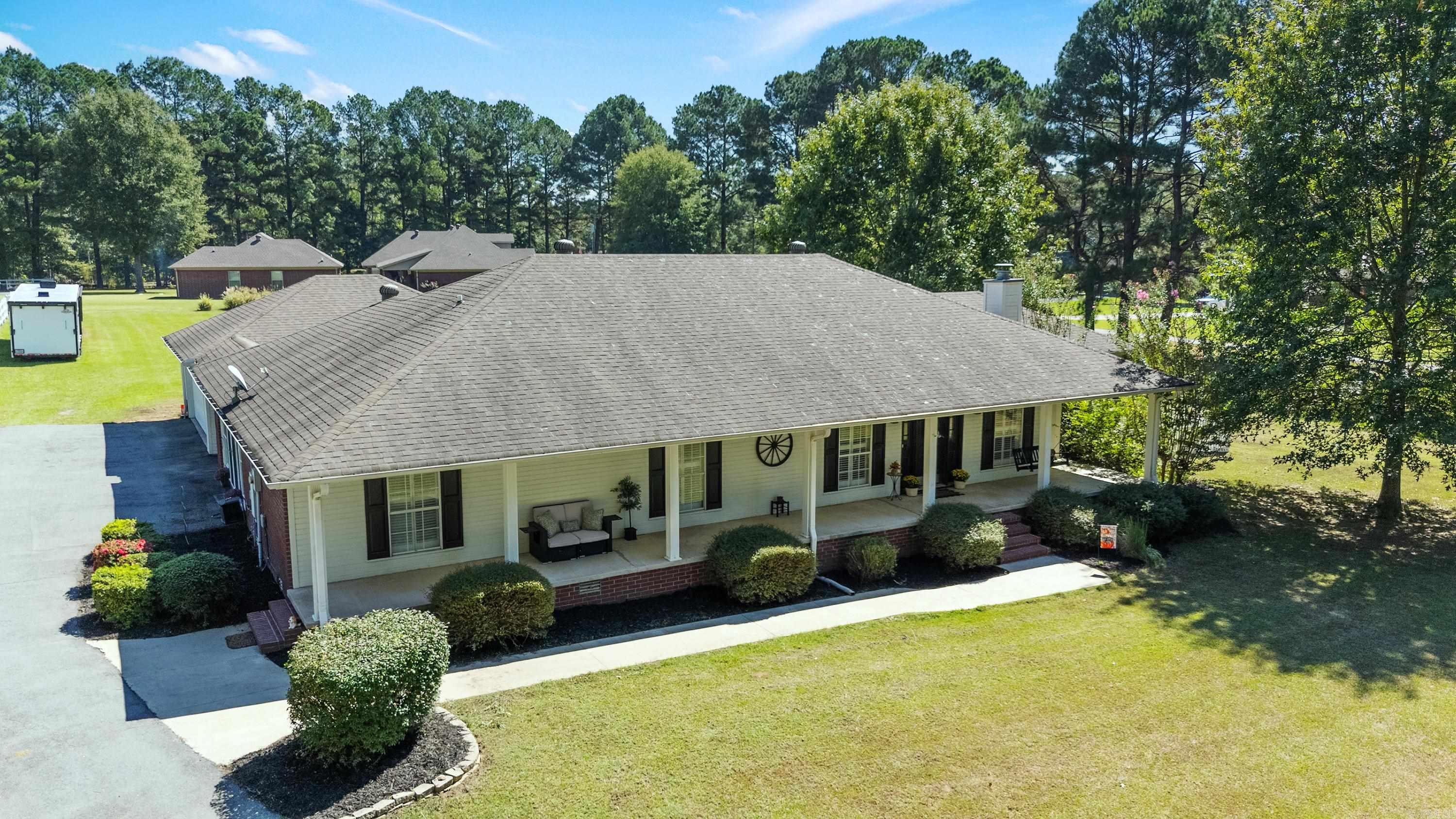 Beautifully updated home on a level 3.16 acre lot with a barn and fencing for horses. The wide front porch welcomes you inside to fresh paint colors, vaulted ceilings, hardwood floors throughout, and detailed millwork in the living, kitchen, and dining rooms. The spacious kitchen features granite countertops, stainless steel appliances, and abundant work space. A formal living room with fireplace adds warmth and charm, and a large bonus room with two closets and a full bath offers flexible living options. The oversized dining area opens with French doors to a pergola covered deck that is perfect for entertaining. The private primary suite also has French doors to the deck, two closets, and a bathroom with a jetted soaking tub. Outside you will find a low maintenance vinyl fenced yard, oversized two car garage with storage and a workbench, and a barn with stalls, water, electricity, and storage. The home has been pre inspected so you can buy with confidence. **Agents see remarks