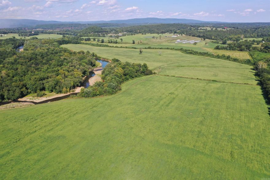 This Beautiful Pope County farm has multiple improvements to benefit your farming operation on many different levels! Sprawling a vast 283 +/- Acres and being composed of nearly all hay meadow and grass pasture, this well-maintained farm has been groomed with productivity in mind. Along with the three-house poultry operation, the farm has great recreational opportunities along the spectacular Illinois Bayou.  • 283 +/- Acres • 1 Mile of Year-Round Illinois Bayou Frontage • Three Poultry Houses with Current Tyson Contract • Newly Constructed 40x80 Litter Shed • 60x80 red iron barn • 2010 Model 2128 sq. ft. Mobile Home • Newly Constructed 40x60 Horse Barn • Cattle Improvements • Fenced, Cross Fenced, Automatic Frost-free waterers • Two ponds • Pipe Corral with multiple sorting pens • Fertilized and well-maintained hay meadows • Great Build sites and views • Pipe Fencing • Great Fishing, Hunting, and recreational opportunities • Tractor and Implements conveying with sale • 90 HP Kubota cab tractor • Kubota Hay Baler • Kuhn V Rake • 4 Basket Kuhn Tedder • 200 Gallon Sprayer • 15 Foot Batwing Bush hog • Two Kuhn 9-foot hay mowers