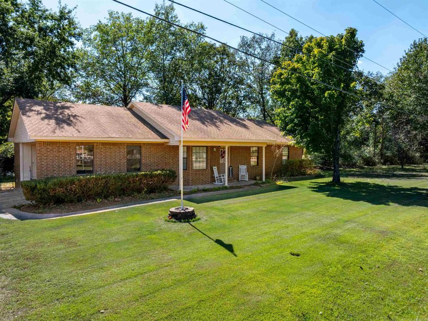 Welcome to your private retreat at the end of Dave Street in Cave City, Arkansas. This charming brick home on nearly one acre offers the seclusion of country living while still being inside the city limits. Step into the backyard and you’ll feel like you’re on 20 acres—peaceful, private, and perfect for enjoying the outdoors, gardening, or entertaining on the large back deck. Inside, this home offers a spacious layout with a large living room featuring a bay window, a dining area with French doors opening onto the deck, and a newly updated kitchen with fresh paint and appliances. The primary suite includes an extra-large walk-in closet and private bath with makeup vanity, while the additional bedrooms are generously sized. A detached shop with electric, insulation, and wood heat makes this property as functional as it is beautiful.
