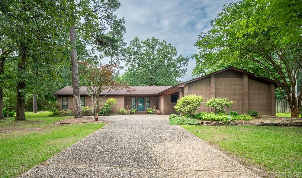 Beautifully maintained by the original owner, this brick one level is located on a lush half acre lot on a quiet cul-de-sac. Excellent floor plan with a cool mid century vibe for the exterior. The home features 3 bedrooms with 2 full baths plus a half bath. Huge, oversized great room with WBFP converted to gas logs, dry bar that has been plumbed - could be easily converted to wet bar. Kitchen with breakfast bar, built in stove, walk in pantry, built in desk. Fridge is negotiable. Formal dining room. Primary bedroom has great closet space and two built-in chest of drawers and full bath. Separate laundry room. Seller connected to city sewer line in '24 - there is a pump grinder. Large, park-like backyard with beautiful landscaping and inviting patio backs up to green space. Lots of outside storage. Seller providing a home warranty with First American Home Warranty - Eagle Premiere