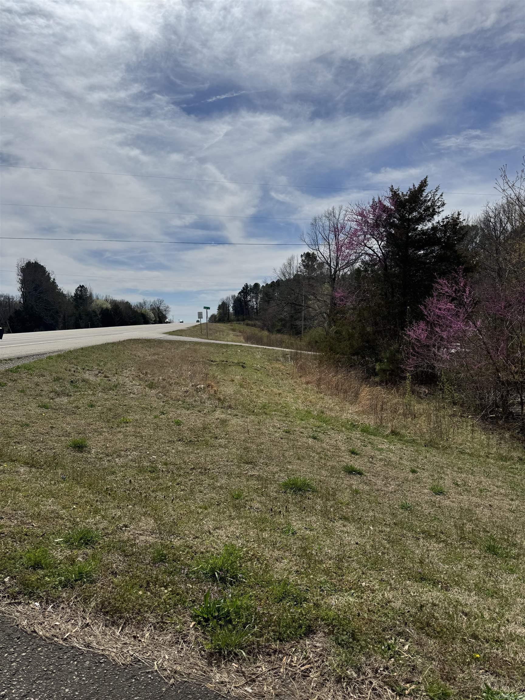 Large corner lot with highway frontage. No restrictions and a lot of potential. Best for commercial services and multi-family residential. Lot is sloped in the front and levels out in the back.