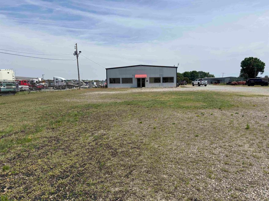 Former location of Eastside Truck Sales.  Property is fenced all the way around it.  It is divided into 2 sections.  There is water faucet and sewer drain for RV's at the Front of property.  2 dog pens with concrete floors and roof.  There is also a 3 bay carport.  Large office inside with picture windows.  Kitchen.  1 1/2 baths.  Full bath with shower in front.  1/2 bath in shop.  Storage space up above kitchen and office area.