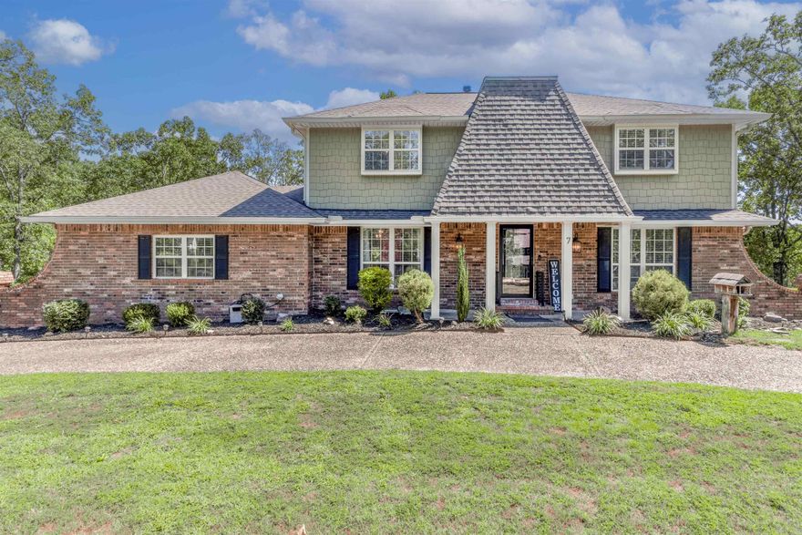 Discover this beautiful 4-bedroom, 3-bath home tucked away in a quiet cul-de-sac in the highly sought-after Indian Hills subdivision of North Little Rock. With nearly 2,800 sq. ft. of living space, this home offers both space and comfort.  Inside, you’ll find a welcoming layout with hardwood and tile floors, spacious living and dining areas, and a cozy fireplace that creates a perfect gathering spot. The main-level primary suite offers convenience, while three additional bedrooms upstairs provide plenty of room for family, guests, or office space.  The exterior features wood siding accented with stone, giving timeless curb appeal. Two decks extend your living space outdoors, overlooking a backyard with a beautiful retaining wall and peaceful lake views. Whether you’re entertaining friends or enjoying a quiet evening, the setting is designed for relaxation. A circle drive and two-car garage provide ample parking.  Conveniently located near shopping, dining, and schools, yet nestled in a private cul-de-sac, this home combines charm, function, and a location that’s hard to beat.