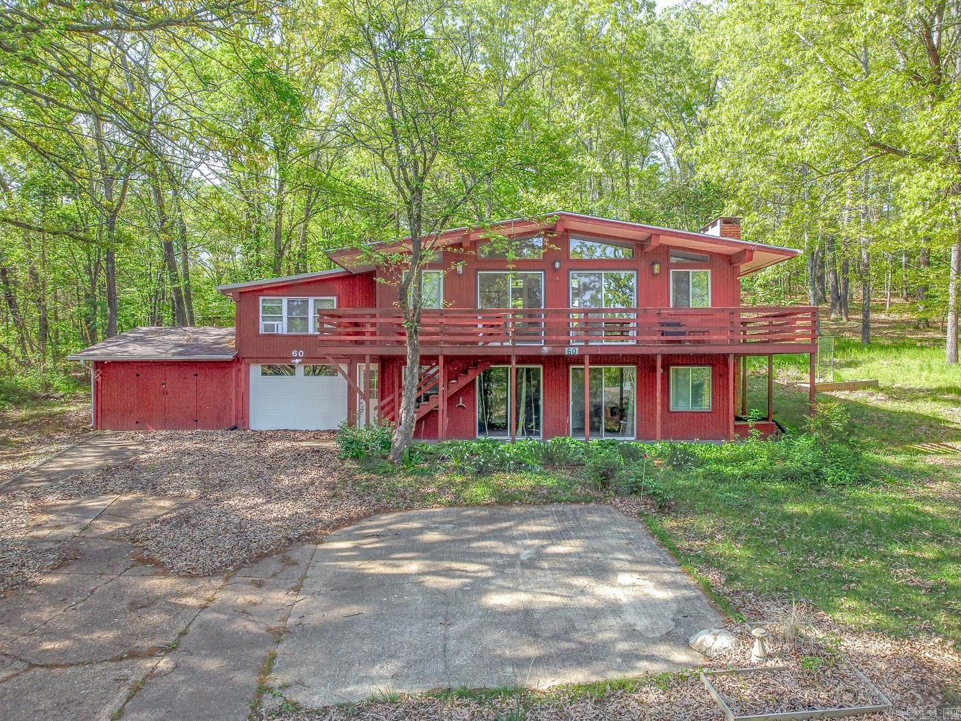 Welcome to the market 60 Cherokee Rd in Cherokee Village, Arkansas! WATER, GOLF, VIEW!!! This stunning remodeled house has all three. AIR BNB Ready! All furnishings stay. Great investment opportunity so close to the river you can hear it! Walk out your front door and down to the South Fork river, cool off, drop your kayak in, float on a tube, fish one of THE best smallmouth streams anywhere, walk or ride your golf cart to the North Golf course "which you are a member of" play a round, and finally enjoy your beautiful wooded setting with all the privacy you will want and look for in the Ozarks!!! 3 bedrooms, 2 living rooms, 3 baths with another bonus room over the garage right off the kitchen, two fireplaces (electric) and a large game room gives you all the space you'll need with tons of storage, and extra area for a shop for those kayaks and golf cart. You will love the large deck that takes full advantage of this great setting and location, perfect for morning coffee or a nice evening relaxing at sundown. New roof, newer heat and air. This LOCATION is worth a look today! Call now for an appointment!! Golf cart is negotiable with reasonable offer.