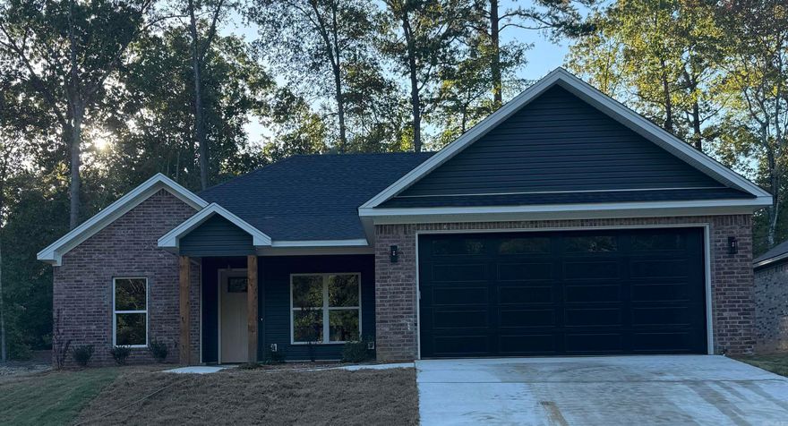 Brand New Construction in the Heart of Benton! This beautifully crafted 3-bedroom,  2-bath home offers modern living with the charm of custom finishes throughout. Conveniently located with easy access to shopping, dining, and top-rated schools, this home features an open-concept layout, luxury vinyl plank flooring, and a stylish kitchen with granite countertops and stainless steel appliances. The primary suite boasts a spacious walk-in closet and a spa-like bathroom with a custom tile shower. Enjoy an endless supply of hot water with the tankless water heater.  Come home to quiet evenings on the covered back patio and low-maintenance living in a growing community. Move-in ready and waiting for you to call it home!