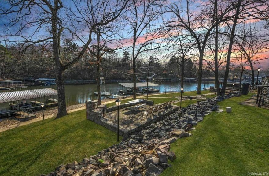 Escape to your personal oasis on Lake Hamilton.  This ground level unit is strategically located just minutes from Hot Springs' , dining, and recreational activities.  This unit owns a boat slip with year-round access.  Noteworthy is the additional living space provided by the glassed sunroom conversion of the back porch with its own climate controlled "mini-split".  Additional bonus of this unit is that a covered parking space conveys to the new owner.  This unit has been renovated with current modern features and outstanding upgrades.  You must see inside to fully appreciate the value of this unit.