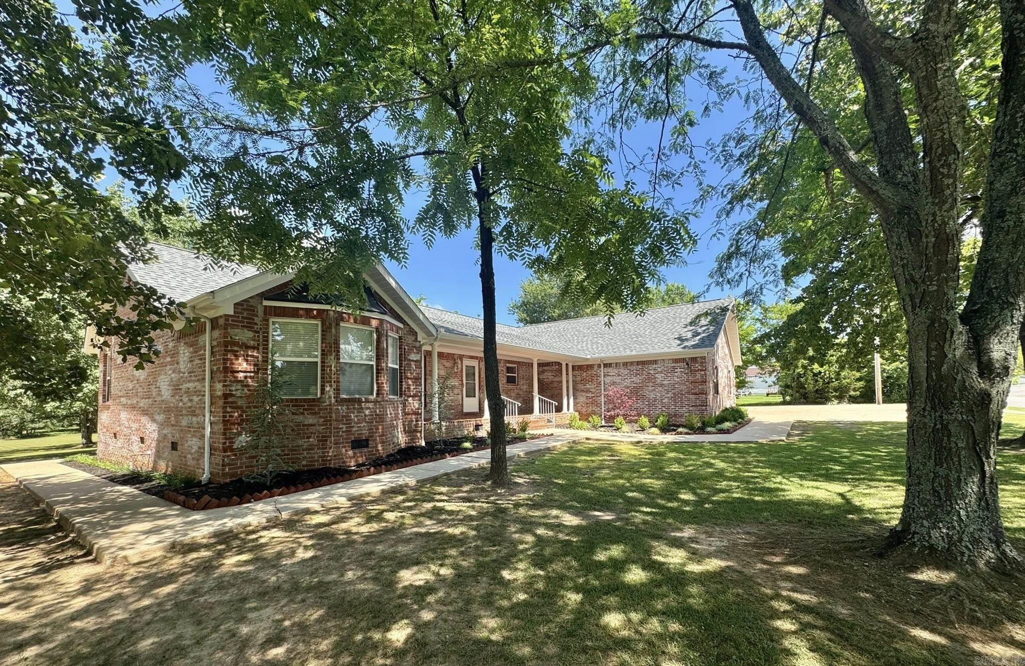 Charming brick home located on 1.14 acres in the heart of Mountain View, Arkansas in city limits. This well-maintained property offers 2 bedrooms and 2 full bathrooms with a desirable split floor plan, providing privacy by placing each bedroom on opposite ends of the home. The spacious layout flows easily into a peaceful, beautifully landscaped backyard—ideal for relaxing, entertaining, or gardening. Enjoy the convenience of an attached 2-car garage and a separate 1-car detached garage/shop that’s perfect for a workshop, extra storage, or your next project. Both the home and detached garage received new roofs in March 2025, ensuring long-term durability. A concrete driveway and full concrete sidewalk wrap around the home, adding curb appeal and ease of access. This property offers the perfect blend of in-town convenience with the feel of a private retreat—move-in ready and full of possibilities.