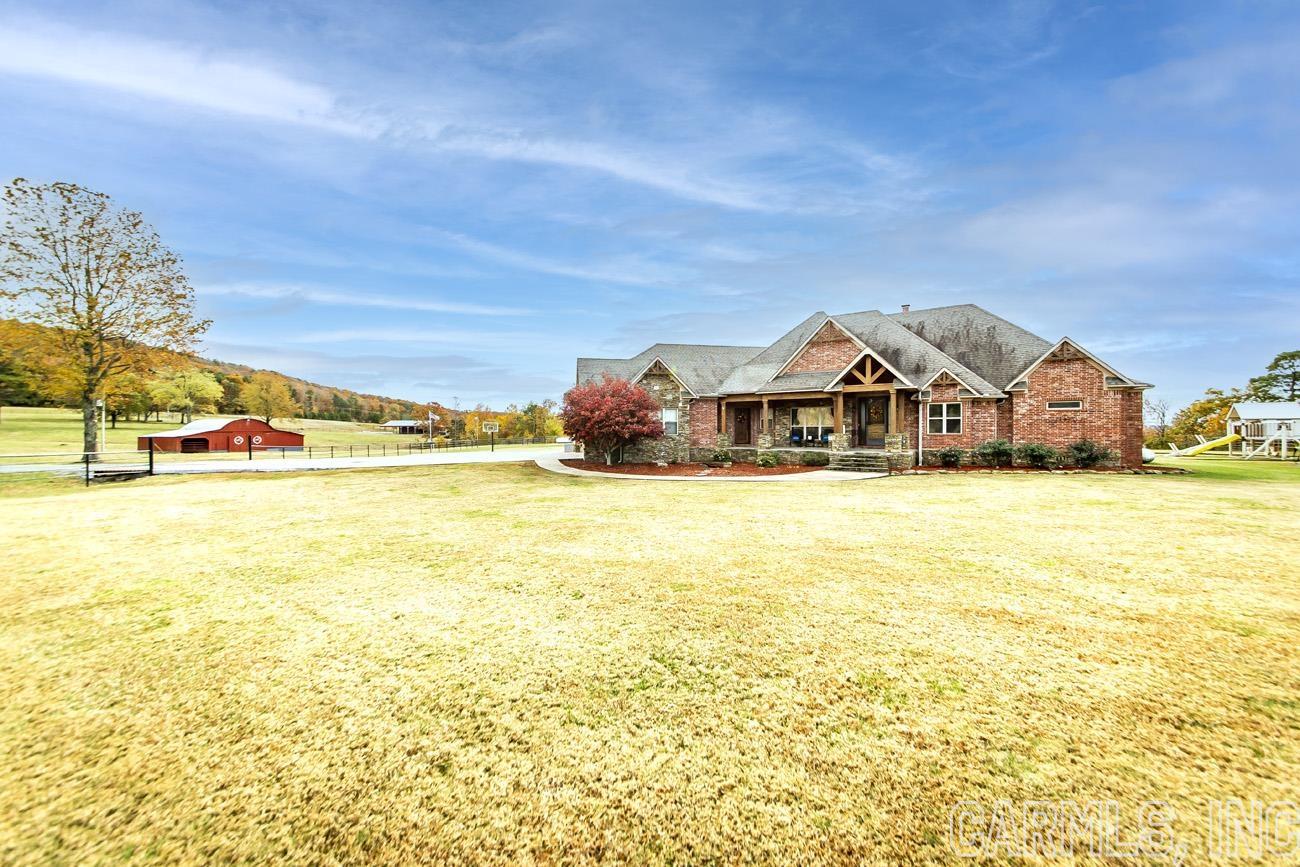 STUNNING VIEWS ARE JUST ONE OF THE MANY BEAUTIFUL FEATURES OF THIS HOME! ENJOY ENTERTAINING FRIENDS AND FAMILY INDOORS OR OUT WHILE WATCHING THE SUNSET FROM YOUR OUTDOOR KITCHEN, HEATED INFINITY POOL, AND HOT TUB. INSIDE THE HOME THERE ARE 4 BEDROOMS, LARGE KITCHEN, OFFICE, SAFE ROOM, AND LARGE WALK IN CLOSETS. WITH TWO BARNS OUTSIDE, STALLS,  A POND, AND FENCING THIS IS THE PERFECT PLACE FOR LIVESTOCK. THE 40X50 BARN HAS ELECTRICTY, WATER, WOOD STOVE & CONCRETE FLOORS ALLOWING IT TO ALSO BE USED AS A SHOP