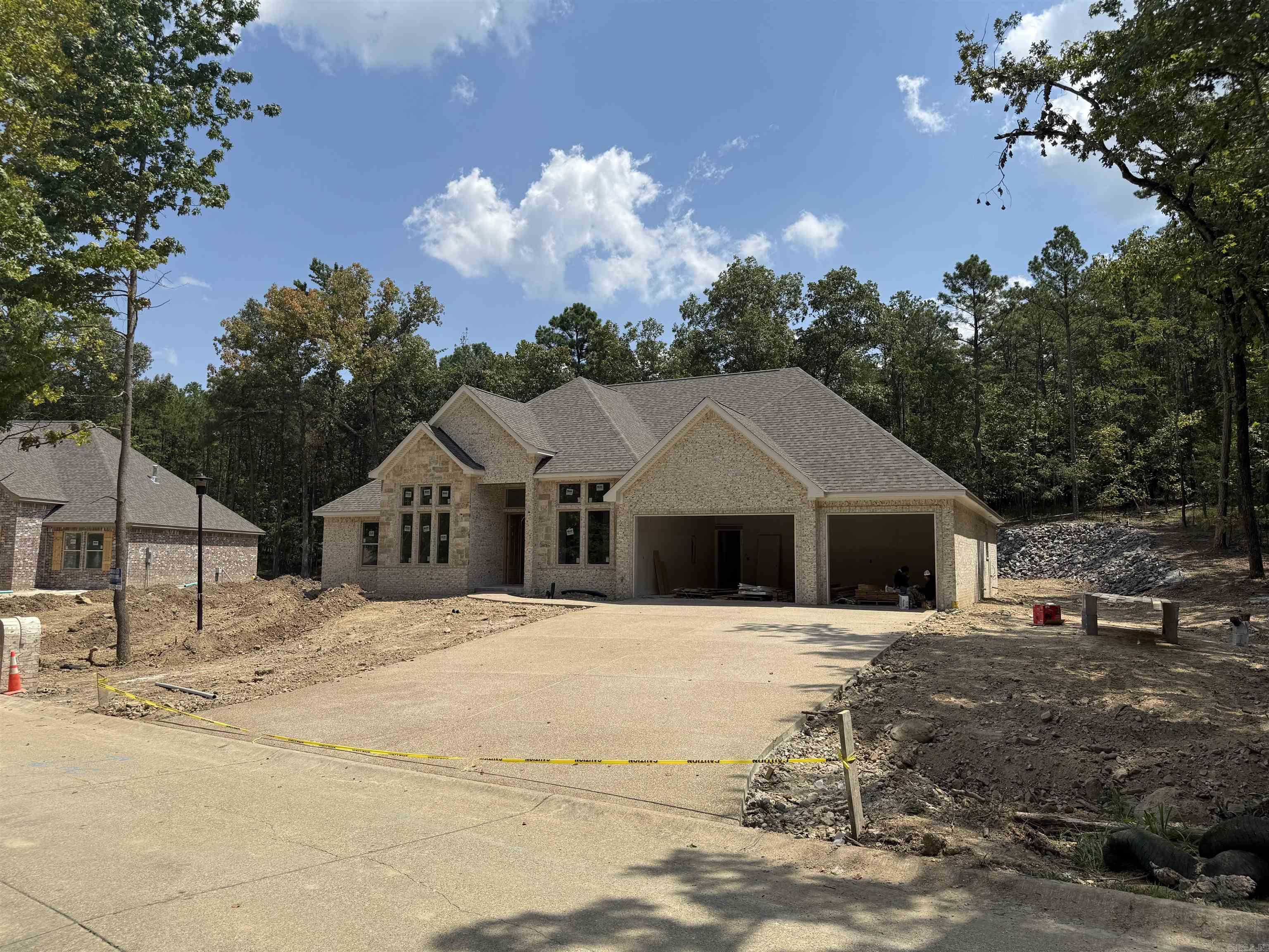 New Construction in Highly Desired 7 South location. Stunning Home with the features you are looking for. Wood beamed ceilings add charm to this open floorplan that welcomes your family and guests. Enjoy cozy holidays around the fireplace. Large granite island in the chef’s kitchen, double ovens and custom cabinets. The butlers pantry makes entertaining a breeze. The primary bedroom features walk in closet and ensuite with luxurious finishes. Stairs to attic for storage. Deeded lake access. Lake Views , across the street from Lake Hamilton. Estimated completion Fall of 2025.