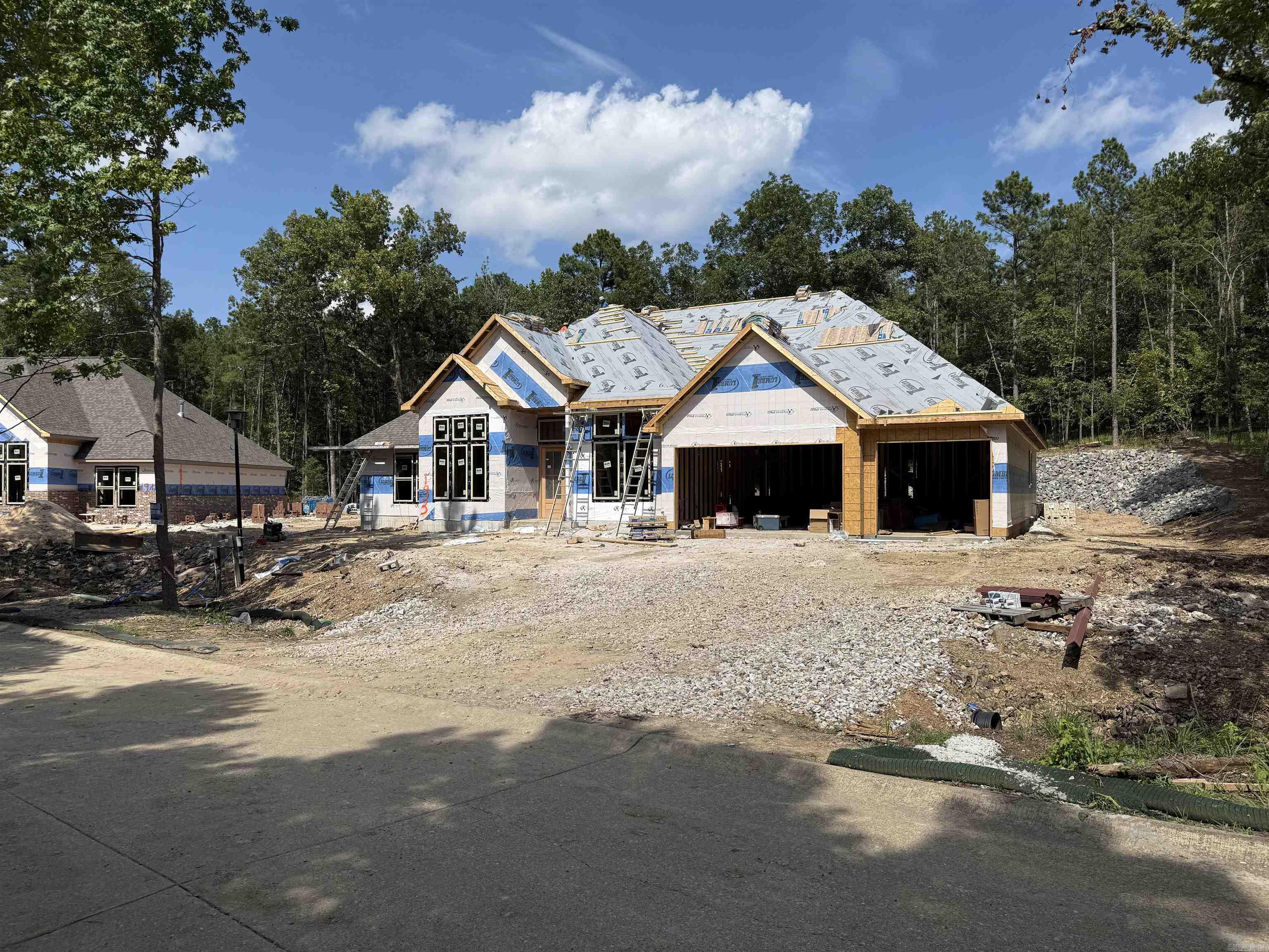 New Construction in Highly Desired 7 South location. Stunning Home with the features you are looking for. Wood beamed ceilings add charm to this open floorplan that welcomes your family and guests. Enjoy cozy holidays around the fireplace. Large granite island in the chef’s kitchen, double ovens and custom cabinets. The butlers pantry makes entertaining a breeze. The primary bedroom features walk in closet and ensuite with luxurious finishes. Stairs to attic for storage. Deeded lake access. Lake Views , across the street from Lake Hamilton. Estimated completion Fall of 2025.