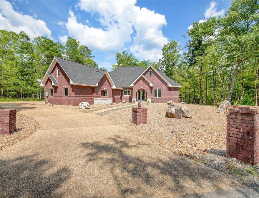 Beautiful custom all-brick home, nestled in a private and peaceful setting near the Coronado Fitness Center, Dolce Vita restaurant and easy access to the Glazypeau gate. Elegant interior features include granite countertops, custom cabinetry, and high coffered ceilings  Enjoy the spacious covered patio, perfect for relaxing or entertaining.  The three-car garage includes a large finished upper level, measuring 33' x 12', offering ample space for storage or a workshop. The finished bonus room, equipped with a mini-split system, adds additional versatility and comfort to the home.  The low-maintenance landscaping adds to the home's appeal, while the stunning floor-to-ceiling windows provide breathtaking views of the private wooded backyard and creek.  Situated on a double lot at the end of a cul-de-sac, this home offers added privacy and a secluded, serene environment making it an ideal retreat.  Plus, with a new roof installed in May 2022, you can enjoy peace of mind in this beautiful home.