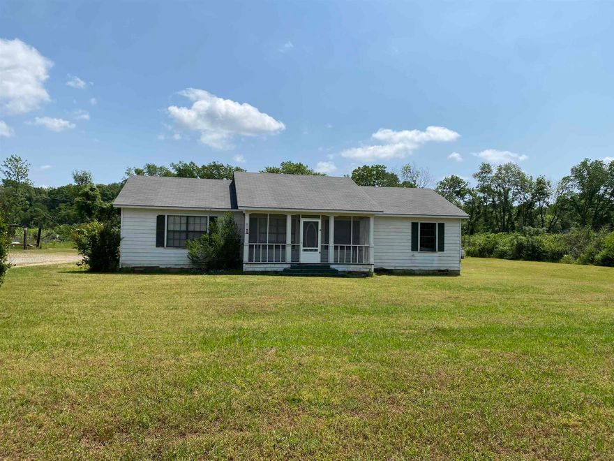Country living, close to town, minutes from the hospital and city park.  This property offers approx 3.46 acres, home and shop building.  The home offers over 1,560 sq ft of living space, 4 bedrooms and 2 full baths.  Large living room, oversized open kitchen/dining area, with breakfast bar, pantry, electric stove and lots of cabinet space.  Large storage room, covered deck and double carport.  Shop building is 30x40, concrete floor, insulated, water and electricity with front and back roll up doors.  Property has natural gas, rural water and internet.  Contact our office for more details.