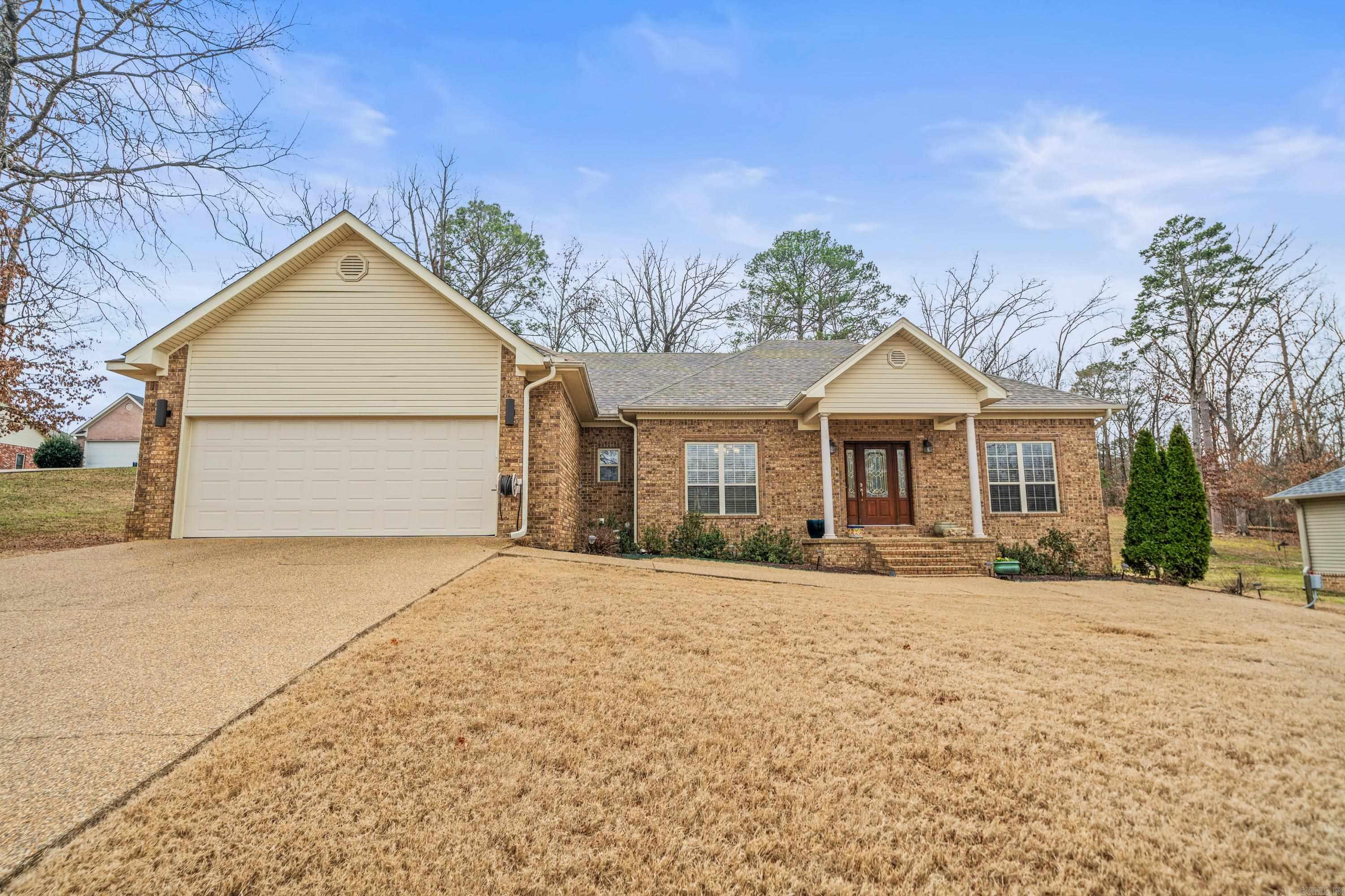 Discover this charming 3-bedroom, 2-bath home on a spacious 0.63-acre lot in Hot Springs, AR. Featuring a split floorplan, the home boasts a large living area with beautiful tray ceilings and abundant natural light. The all-electric kitchen offers tons of cabinet space, perfect for storage and organization. The primary suite includes a generous walk-in closet and a tray ceiling for added elegance. Step outside to enjoy the stunning backyard, complete with a pergola, firepit, and covered patio and newly installed French drains - perfect for both relaxing and peace of mind during rainy weather. New HVAC installed December 2024, water heater and roof less than 3 years old! Conveniently located near local amenities while tucked away for privacy, this home is a must-see.
