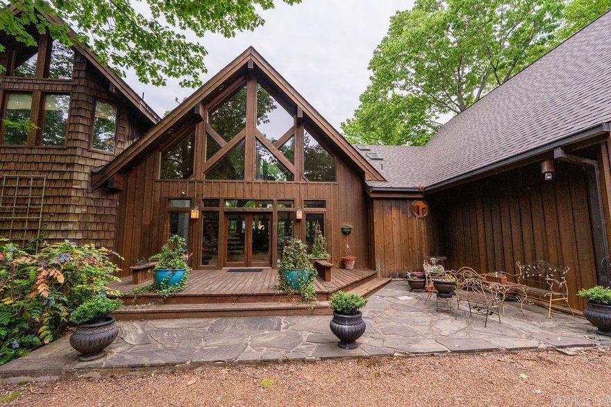 Nestled within the prestigious Tannenbaum Resort, this stunning 3-story lakefront home offers an unmatched blend of luxury & nature. Featuring 6 bedrooms, 5.5 baths, and 5,448 sq. ft., it boasts breathtaking panoramic views of Greers Ferry Lake from multiple vantage points. Step inside to a world of bespoke craftsmanship, where intricate custom woodwork, built-in cabinetry, and exposed beams create an ambiance of timeless elegance. Expansive living areas with floor-to-ceiling windows invite natural light while framing stunning lake views. Enjoy outdoor living with two large lakeside decks, perfect for entertaining or soaking in the serene surroundings. A screened porch offers a peaceful retreat for year-round relaxation. Entertain with ease in the game room with wet bar or escape to the crow’s nest for a spectacular vantage point. A boat slip in the nearby community dock ensures effortless lake access, while a spacious 2-car garage provides convenience. Golf Course, Air Strip, Rec area all within close proximity. Designed for those who appreciate fine craftsmanship and breathtaking scenery, this lakefront oasis offers an exceptional living experience immersed in nature’s beauty.