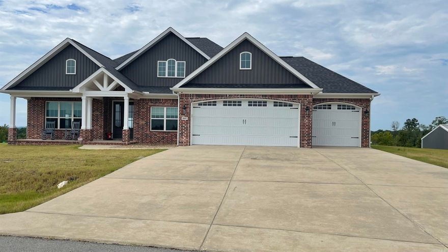 You are going to love to come home to this beautiful all brick home in Kentucky Foothills Subdivision.  Located on 8.5 acres, this 3 BR 2BA home has an ideal open floor plan.  The floors are tile and engineered hardwood floors.  Relax on the covered patio and enjoy one of the most beautiful views you will ever see.  Your whole family will enjoy the open den/kitchen/dining area plus there is a bonus room off the den, which is currently being used as a pool room (yes, the pool table stays).  This room could also be a formal dining room, office or game room.  The master bath has dual vanities, tub, custom shower and the closet is huge!  There are actual stairs to the attic, which is mostly floored and a great area for storage.  The third garage has both front and rear garage doors, so it is easy to pull your boat in.  The 30x40 shop has electricity and is on its own lot, which you could possibly build another home on later.  Seller will leave the refrigerator, pool table and TV in this room, and the 8 security cameras with an acceptable contract.