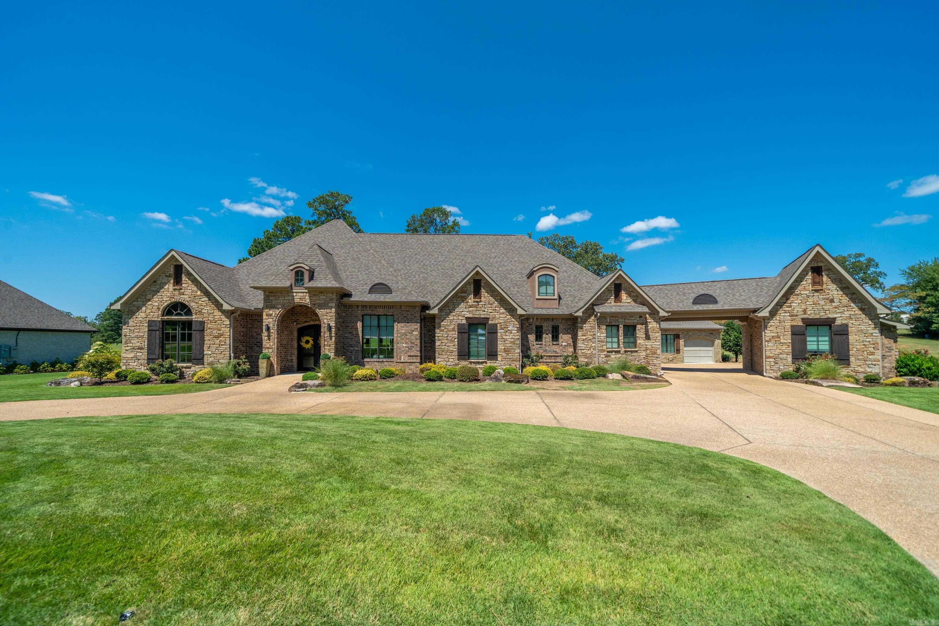 This stunning 5- bedroom, 5.5- bath estate located in the prestigious Arlington Park Neighborhood. Situated on a golf course view lot, this home offers the perfect blend of elegance, comfort, and resort-style amenities. Spacious main residence with open living spaces and luxury finishes. Features a pool, multiple outdoor living areas, office with custom built-ins, large bonus room, full house generator, 5- car garage (one is heated and cooled for temperature control), an additional 1200 sq ft mother-in-law quarters complete with kitchen, living room, bed and bath, and breath taking views of Hot Springs Country Club from your backyard. This property is one of a kind.