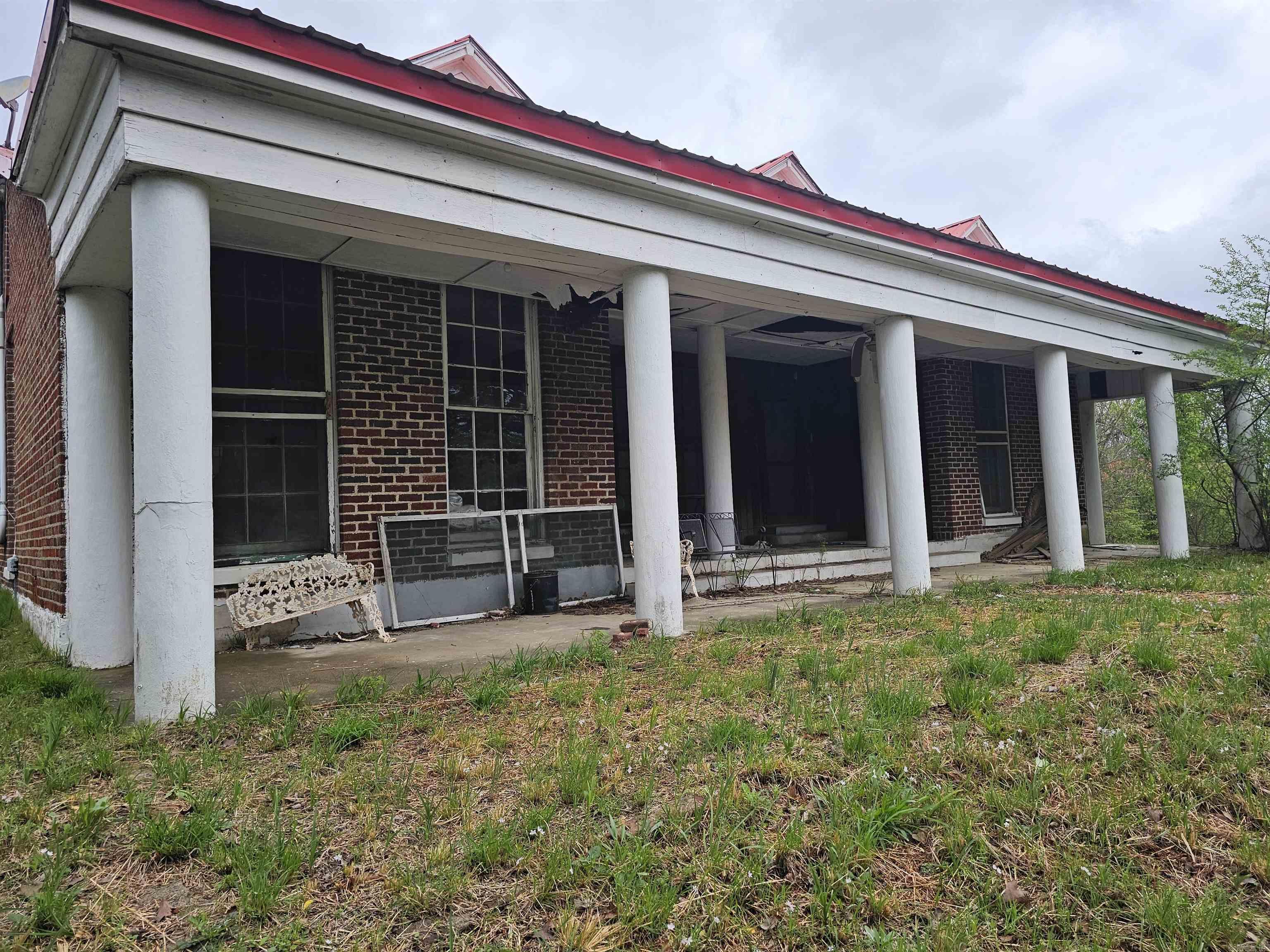 EXCELLENT PRIME COMMERCIAL LOCATION WITH A CREEK at one of the busiest intersections in Mena, Ar. This 2.84 acres has a front entrance on Hwy 71 and back entrances on Pickering and Wagoner, garage, shop and city utilities. Possibilities are endless. The home on Wagoner has no value. Will NOT subdivide. Agents must see remarks all before showing